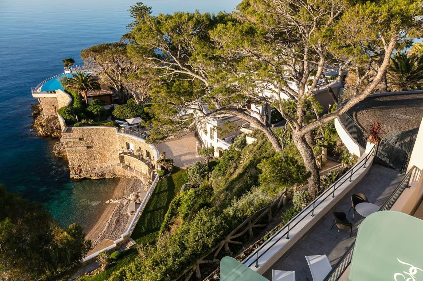 Terraced balconies and structures descending to a private beach cove