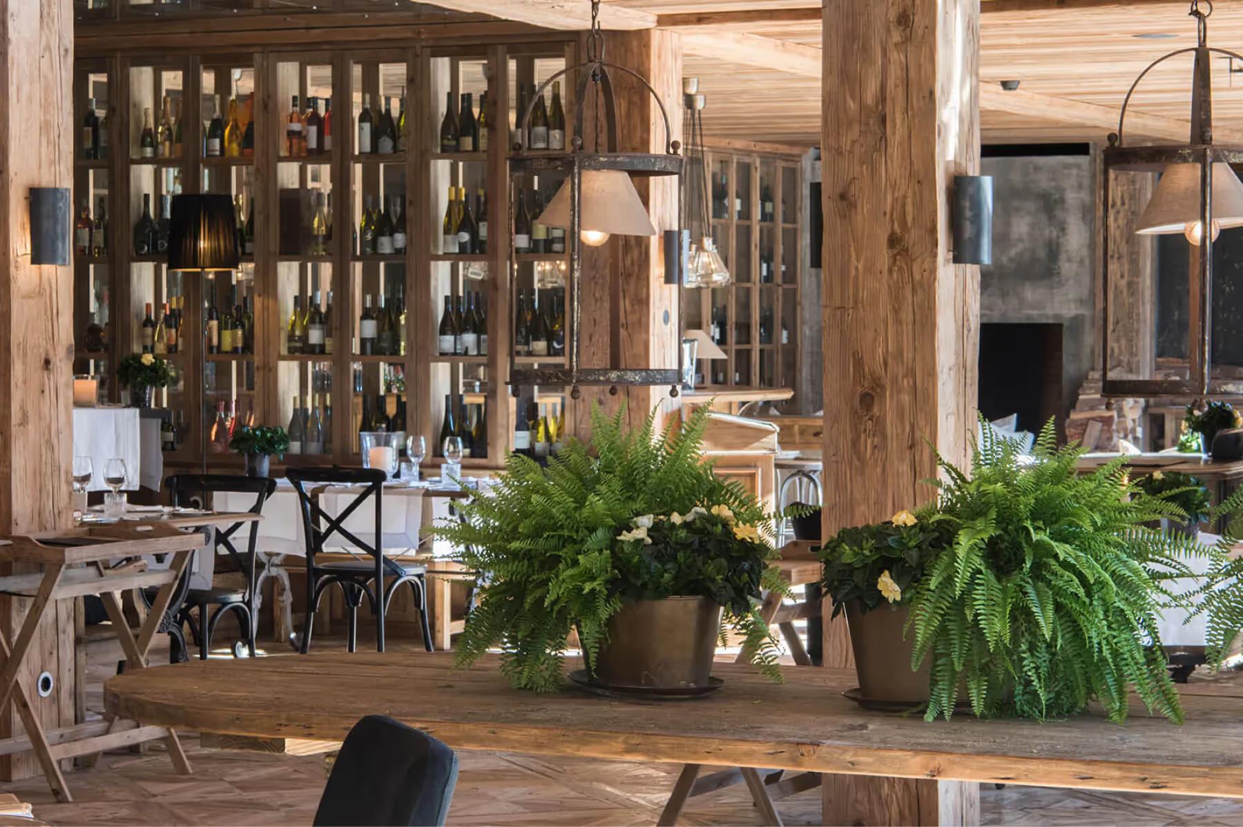 San Luis Retreat: wooden dining area with wine bottles on shelves and fresh produce at table center
