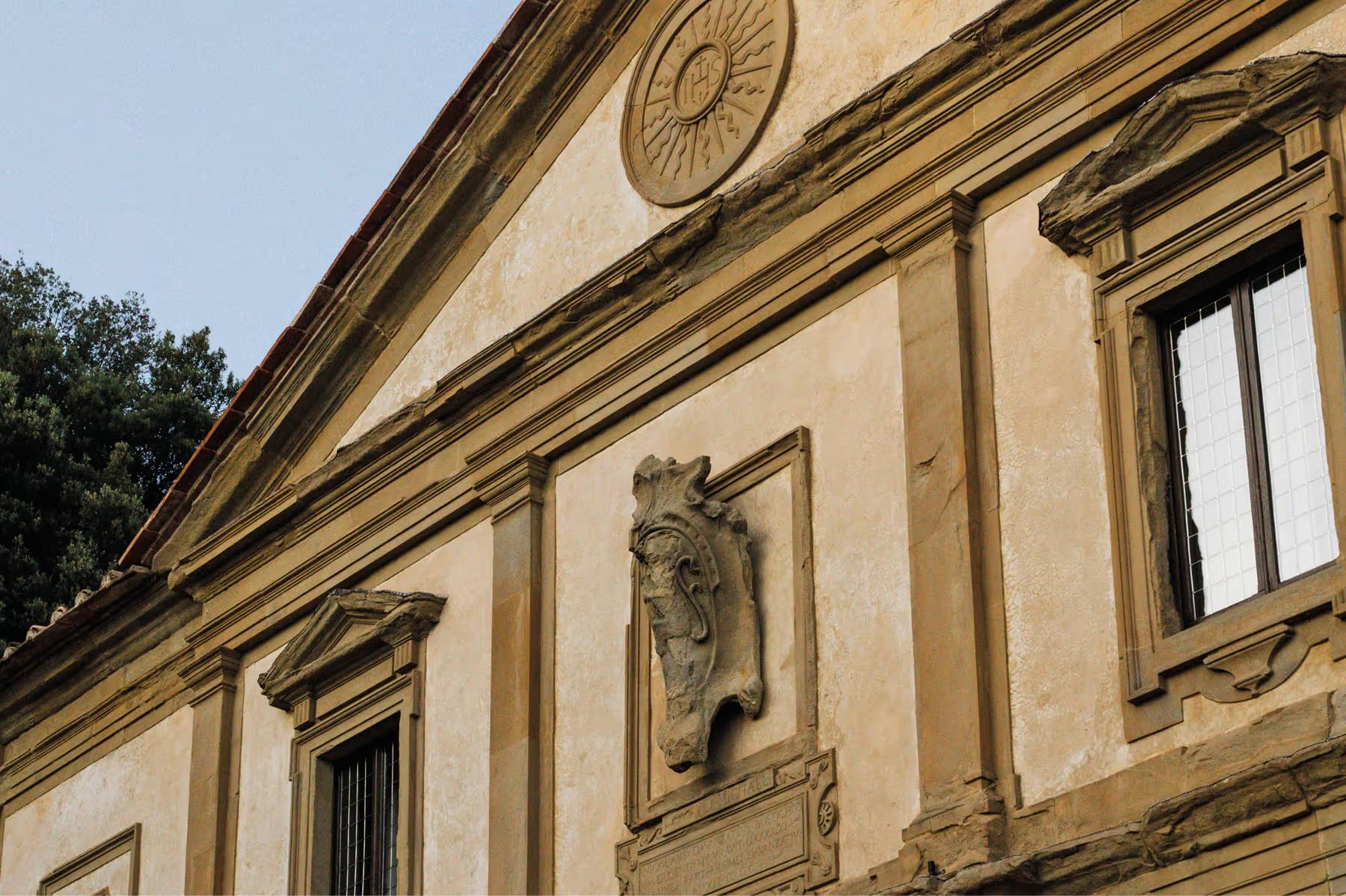 Villa San Michele: stone facade with carved lion head, sunlit moldings, arched windows, and classical architectural details