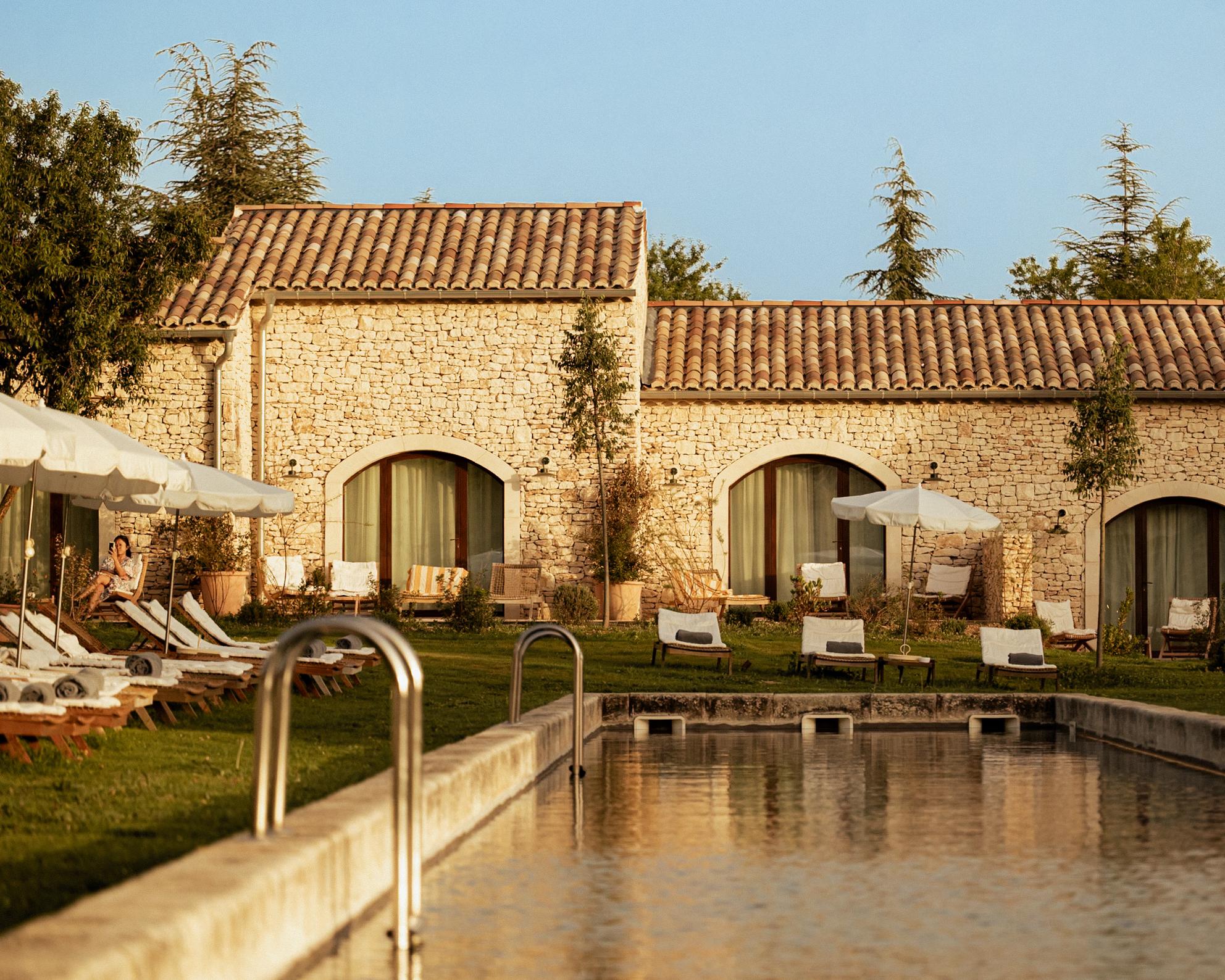 Stone buildings and a garden pool at Capelongue, above Bonnieux