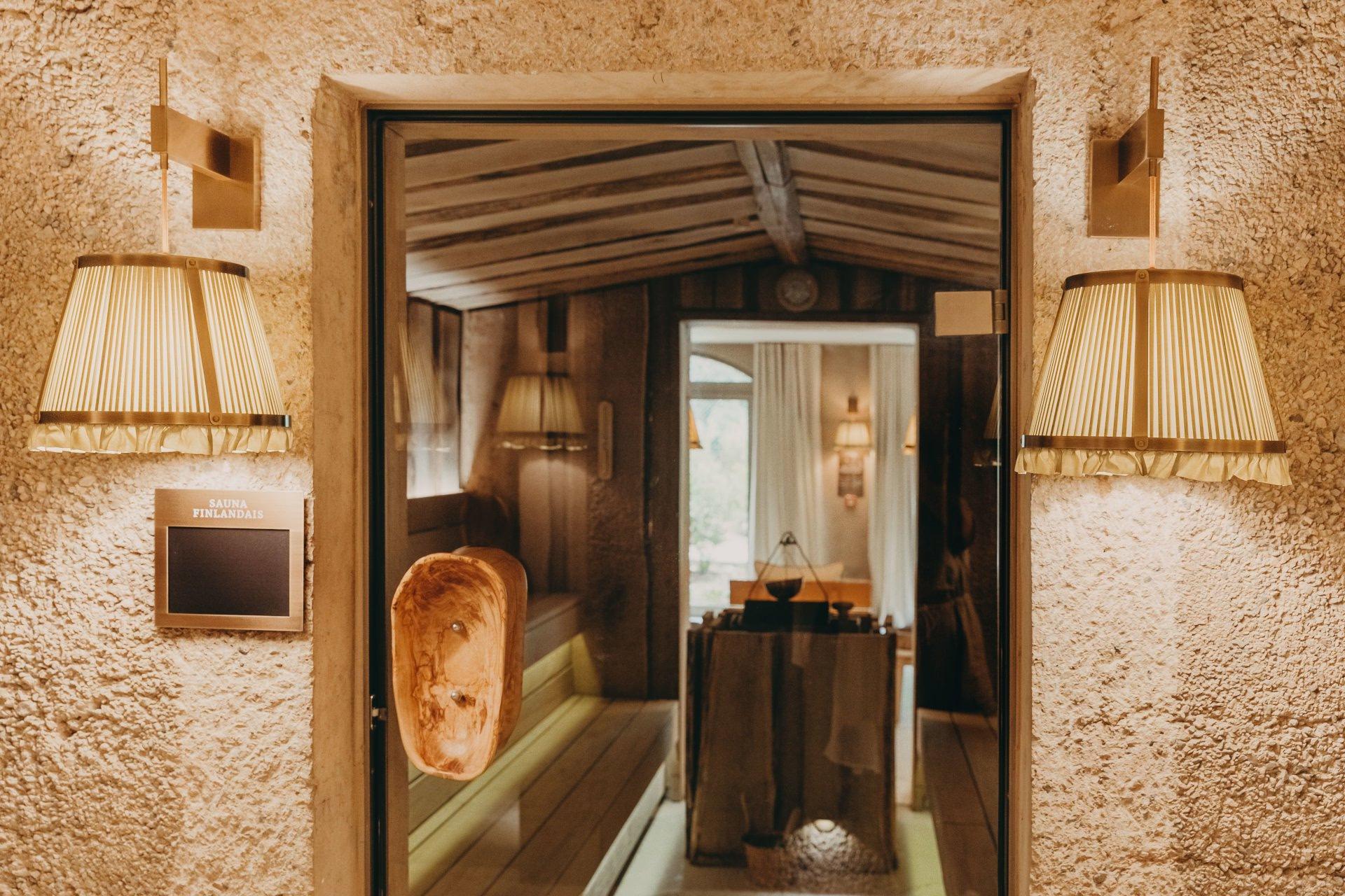Lily of the Valley: entry to spa treatment room with natural stone archway and warm lighting