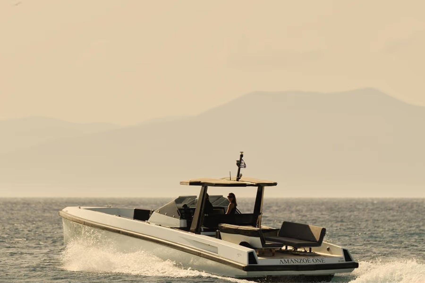 Motorboat departing from shore with mountains in distance