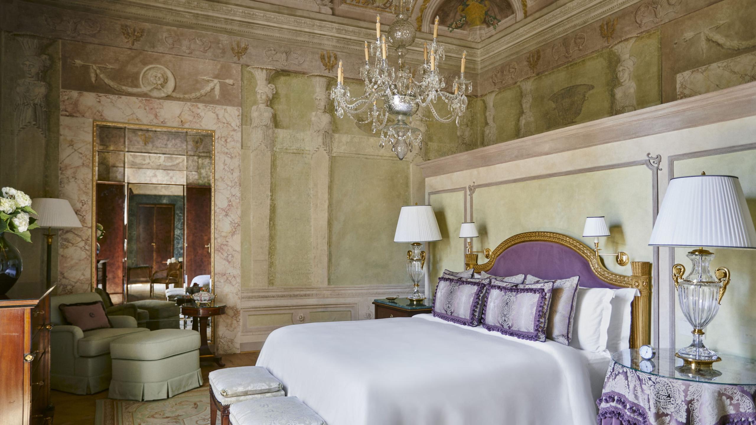 Four Seasons Hotel Firenze: bedroom with frescoed ceiling, pale green damask walls, and windows with cream and lavender drapery