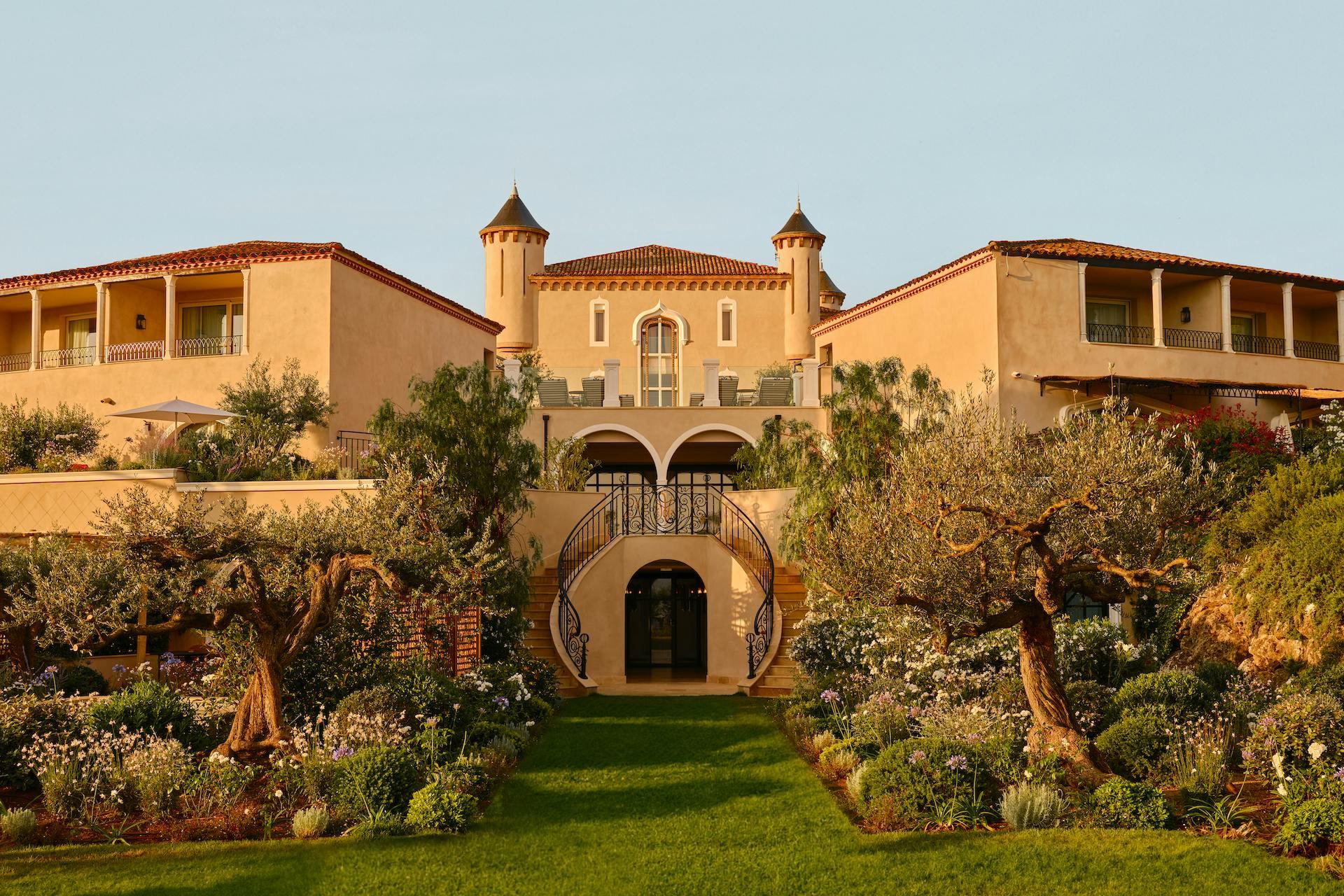Château de La Messardière: terracotta and cream château facade with manicured gardens and cypress alleys