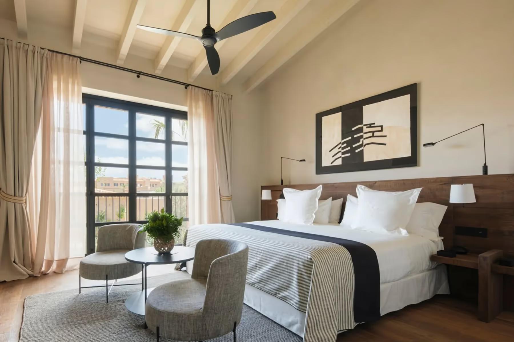Can Ferrereta: contemporary bedroom with platform bed and minimalist decor