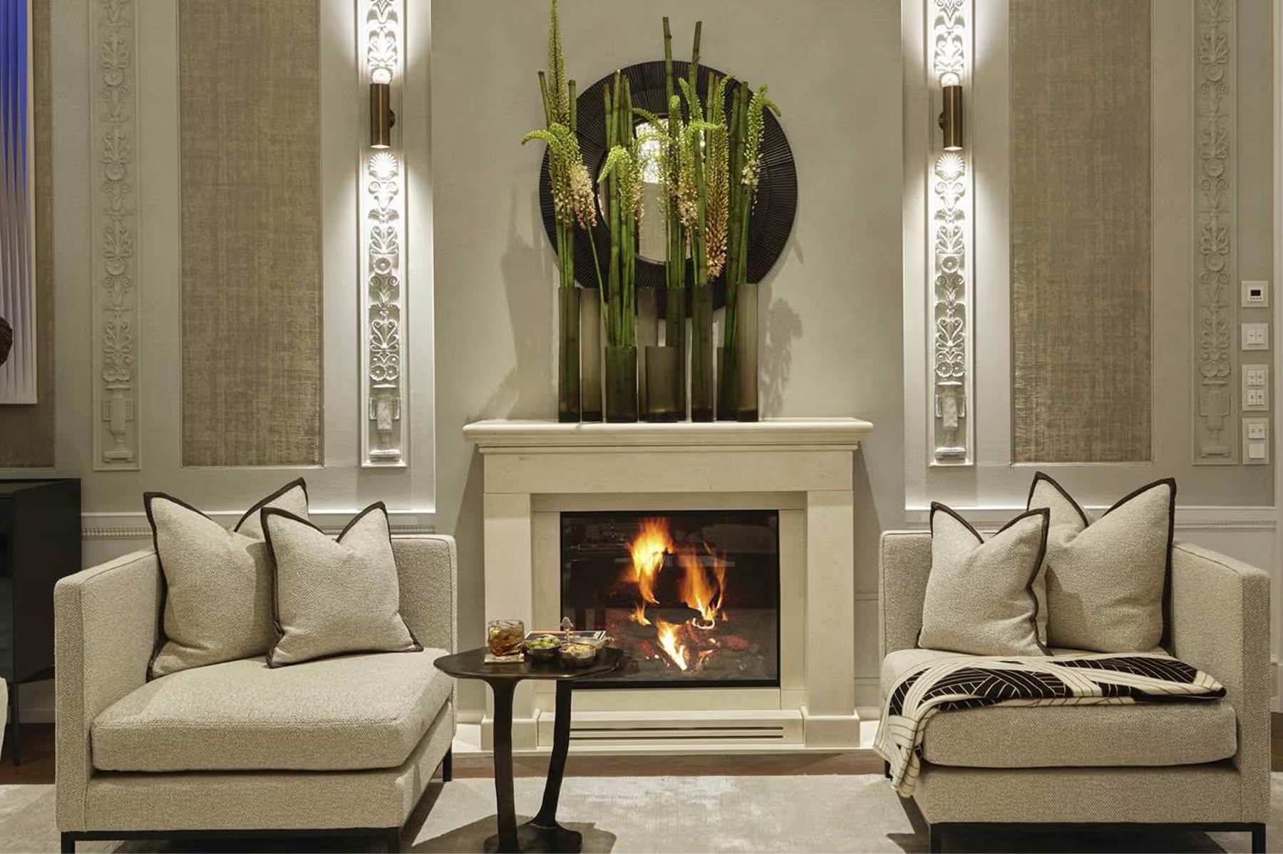 Hotel d’Angleterre: symmetrical lounge with cream sofas flanking a central fireplace