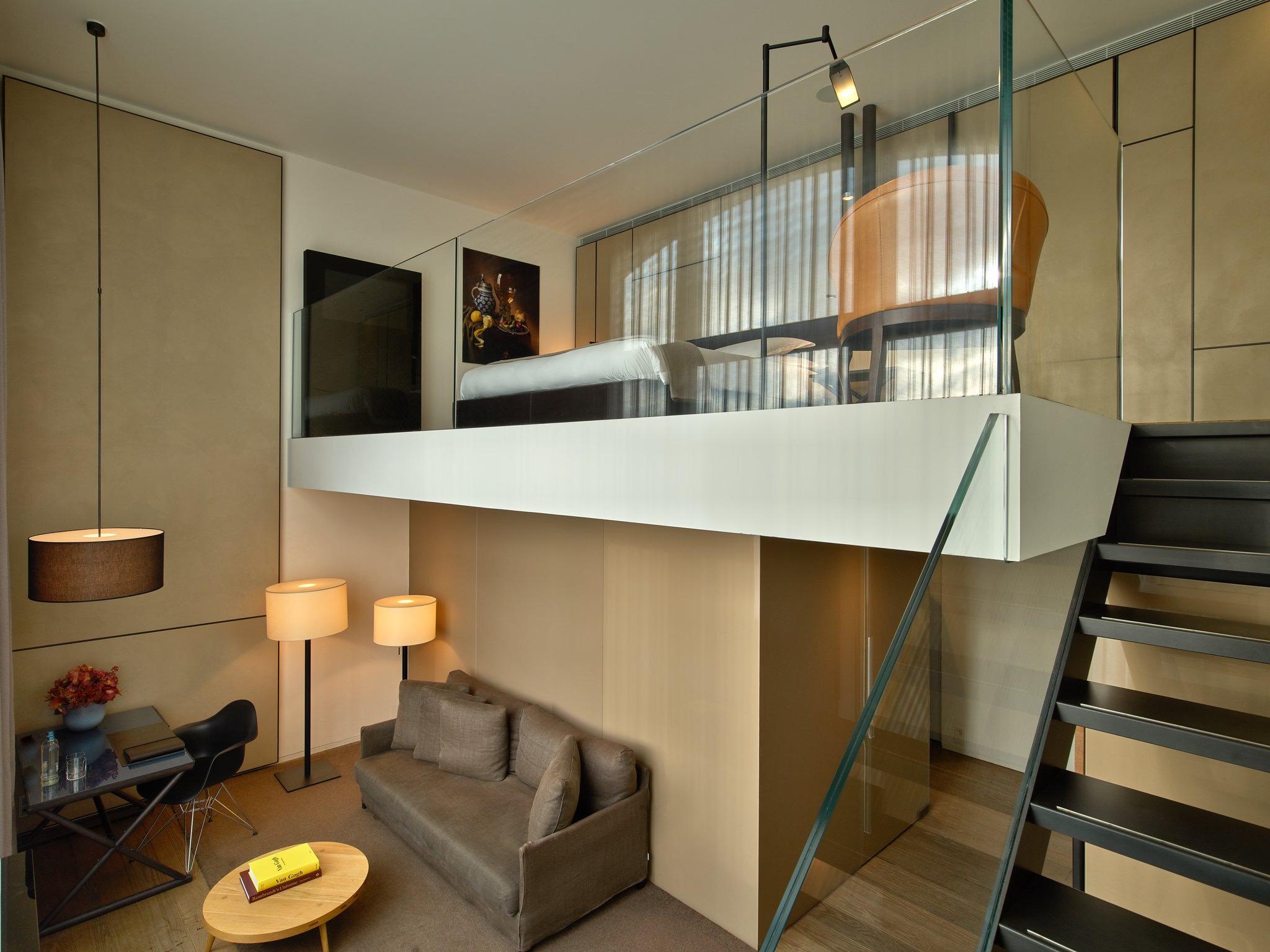Mandarin Oriental Conservatorium, Amsterdam: loft-style duplex bedroom with mezzanine, natural wood finish, and staircase access