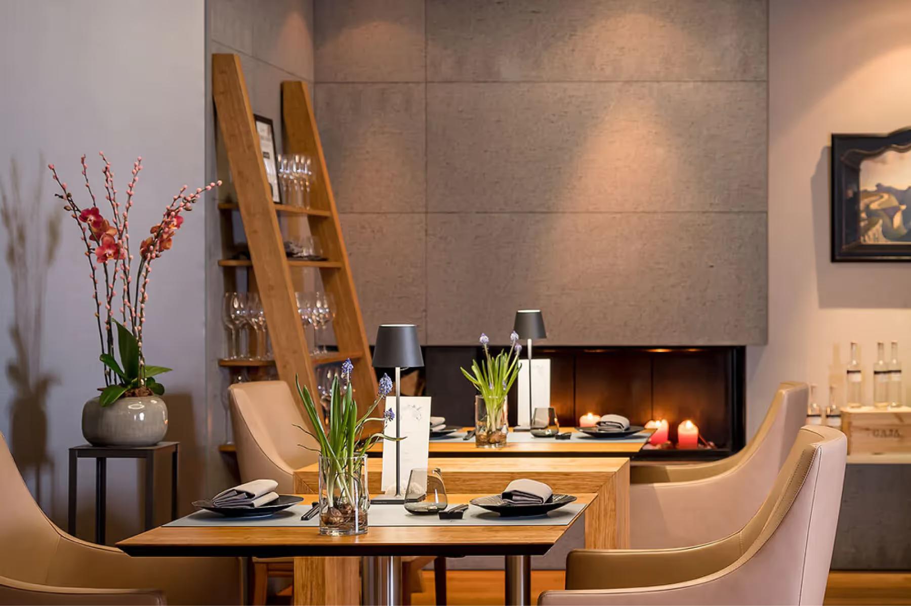 Intimate dining setting with fireplace and curved banquette seating