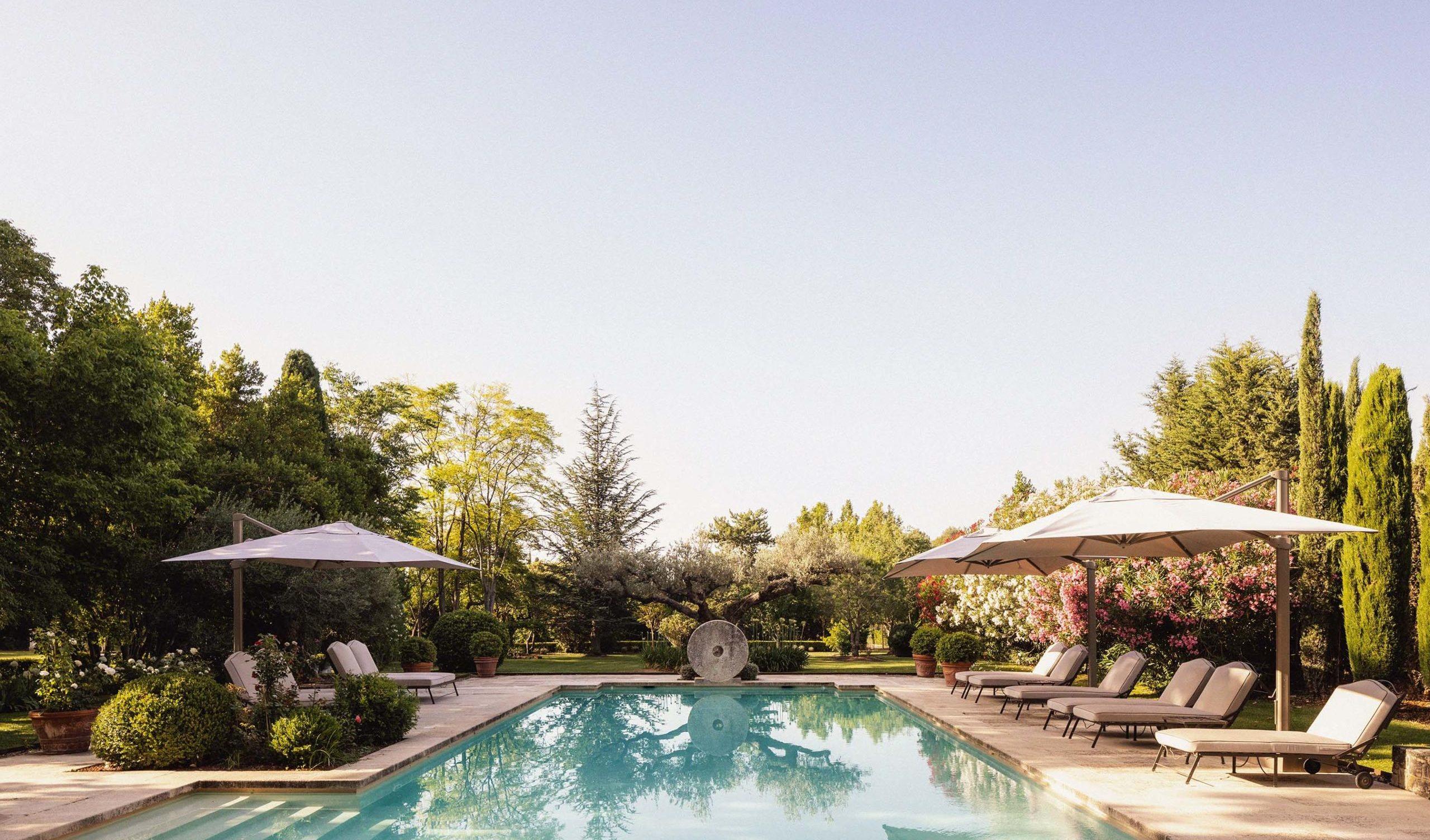 Le Mas de Chabran: heated saltwater pool with loungers and umbrellas surrounded by mature landscaping
