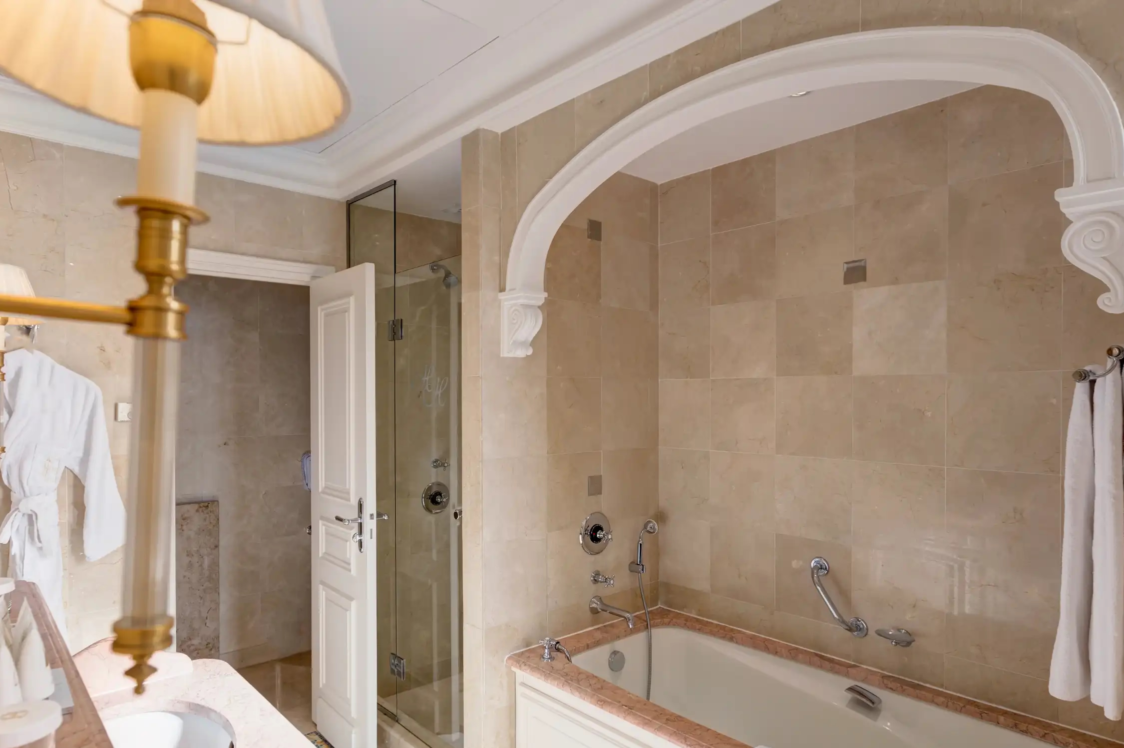 Hôtel Hermitage Monte-Carlo: luxury bathroom with deep soaking tub, arched archway and marble surround