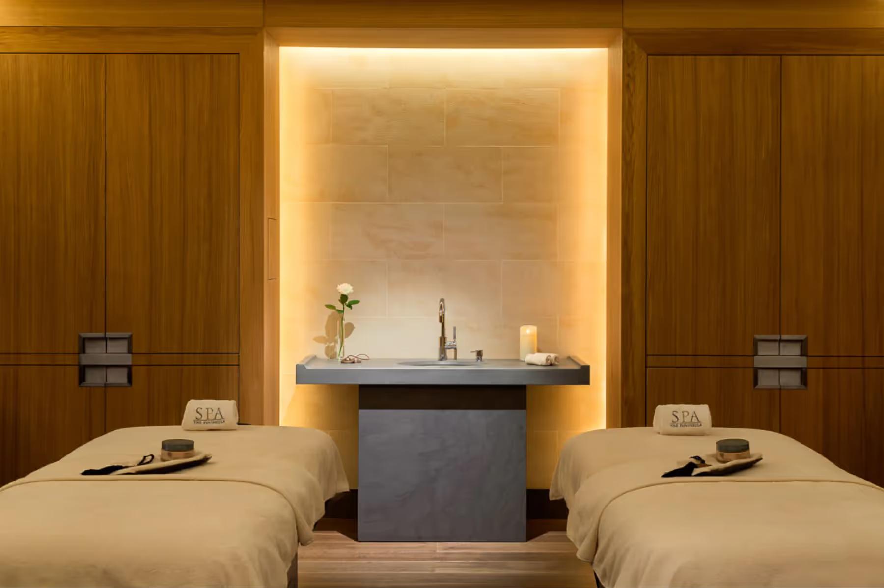 Spa relaxation room with warm wood, lounge seating, and framed coastal artwork