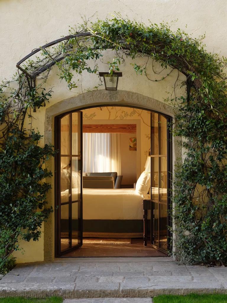 The ivy-framed garden doorway of the Limonaia suite opening onto its bedroom