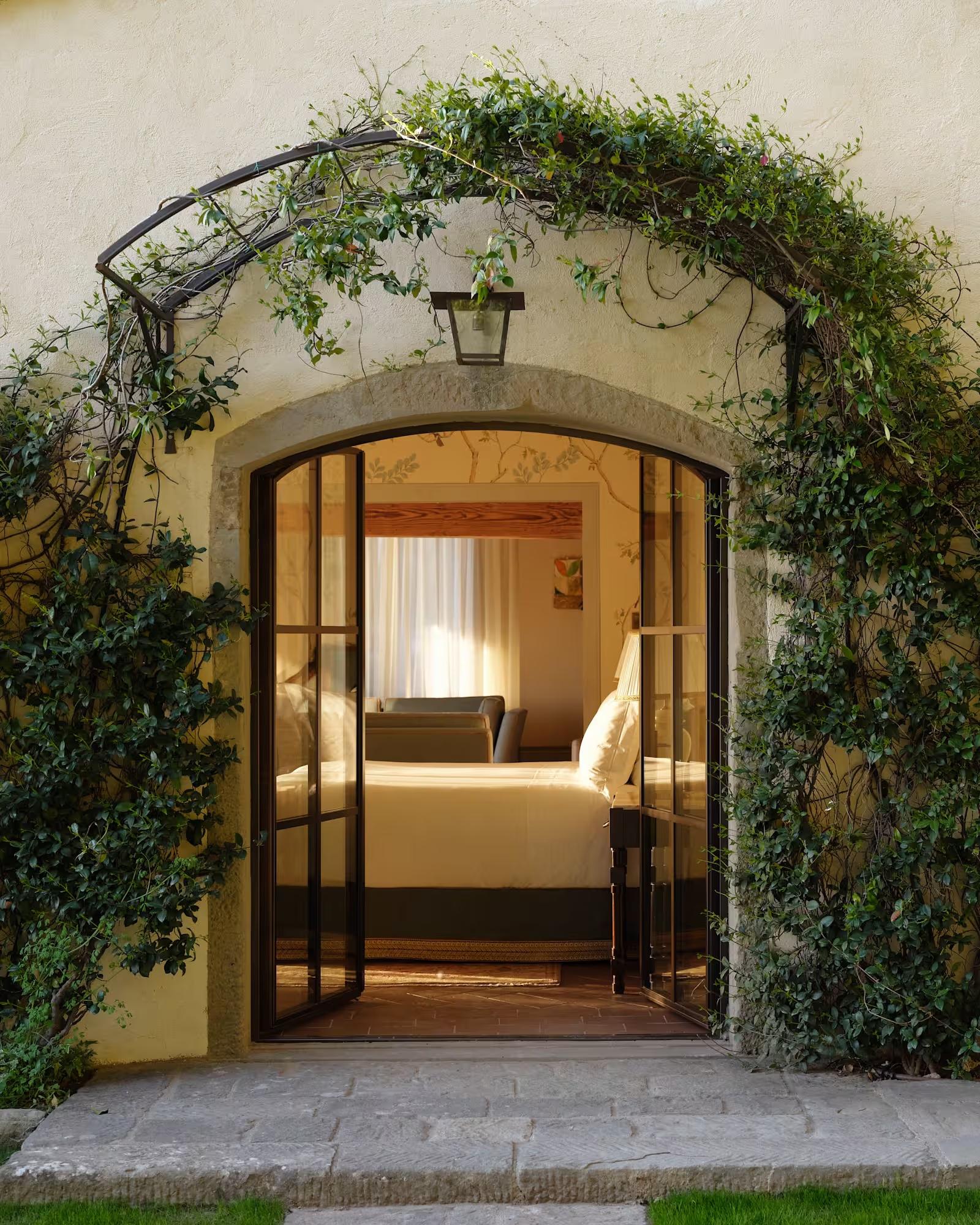 Villa San Michele: the ivy-framed garden doorway of the Limonaia suite opening onto its bedroom