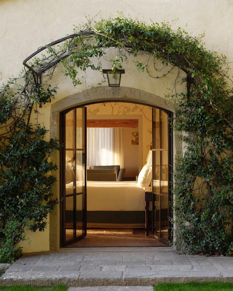 The ivy-framed garden doorway of the Limonaia suite opening onto its bedroom