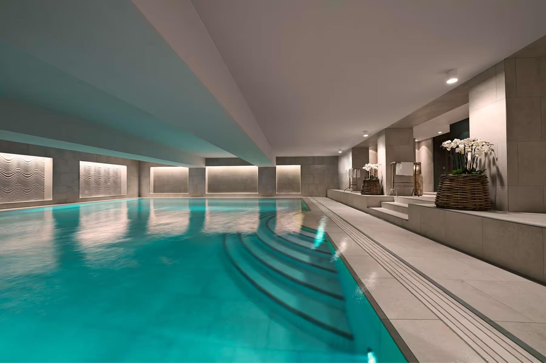 Hotel d’Angleterre: lap pool corridor with pale walls and reflected turquoise water
