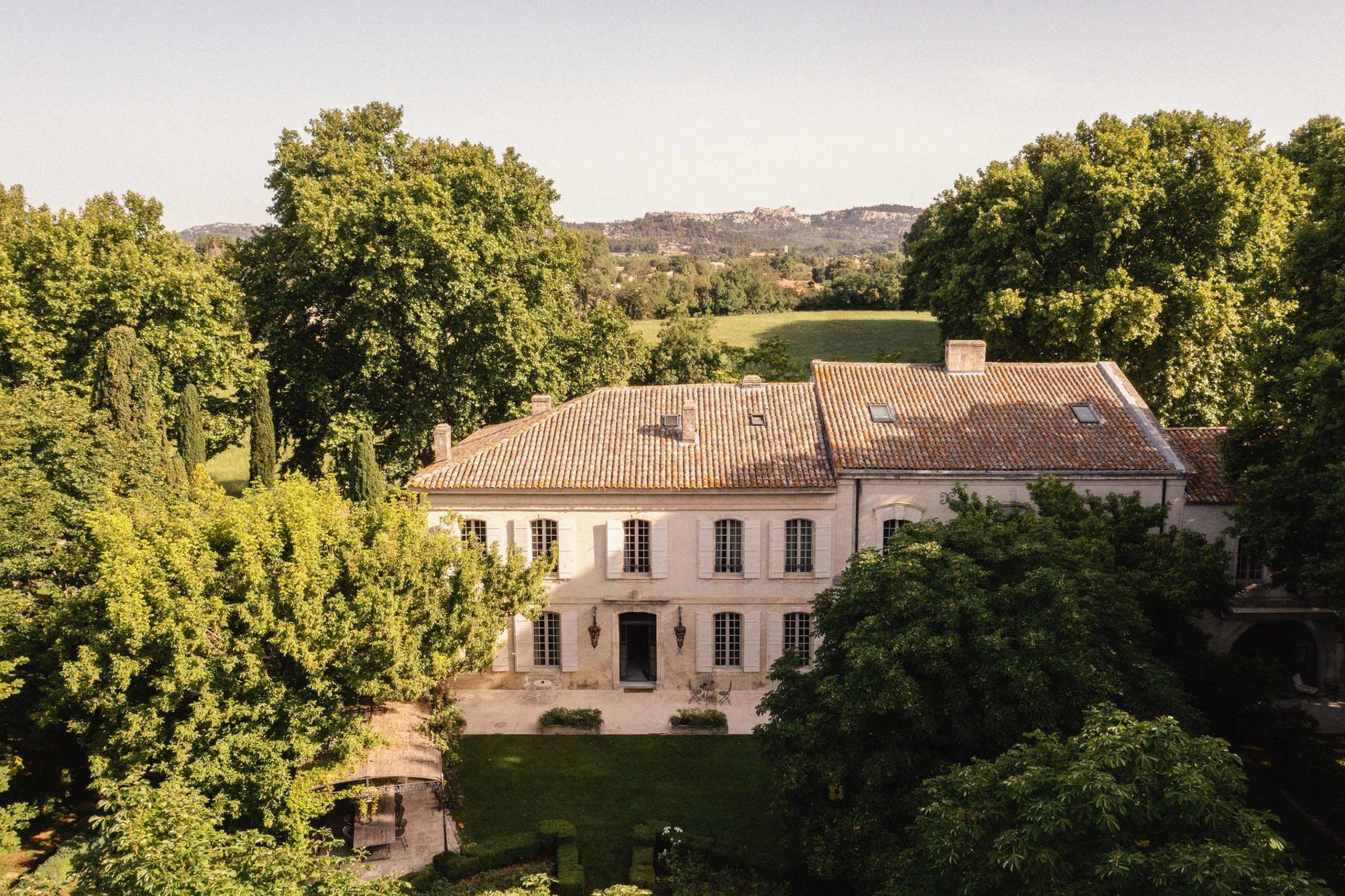 Le Mas de Chabran: aerial view of terracotta-roofed manor set among olive trees with countryside vista