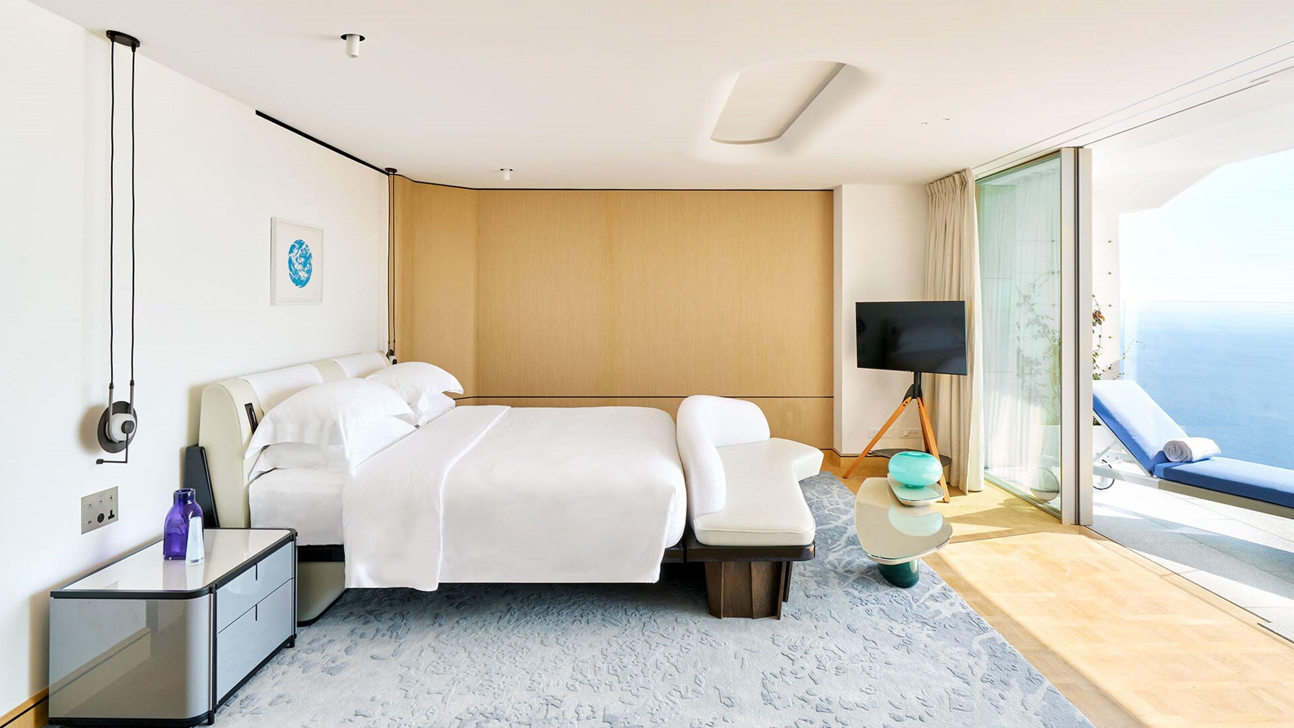 Maybourne Riviera: bedroom with natural wood accents and sea views