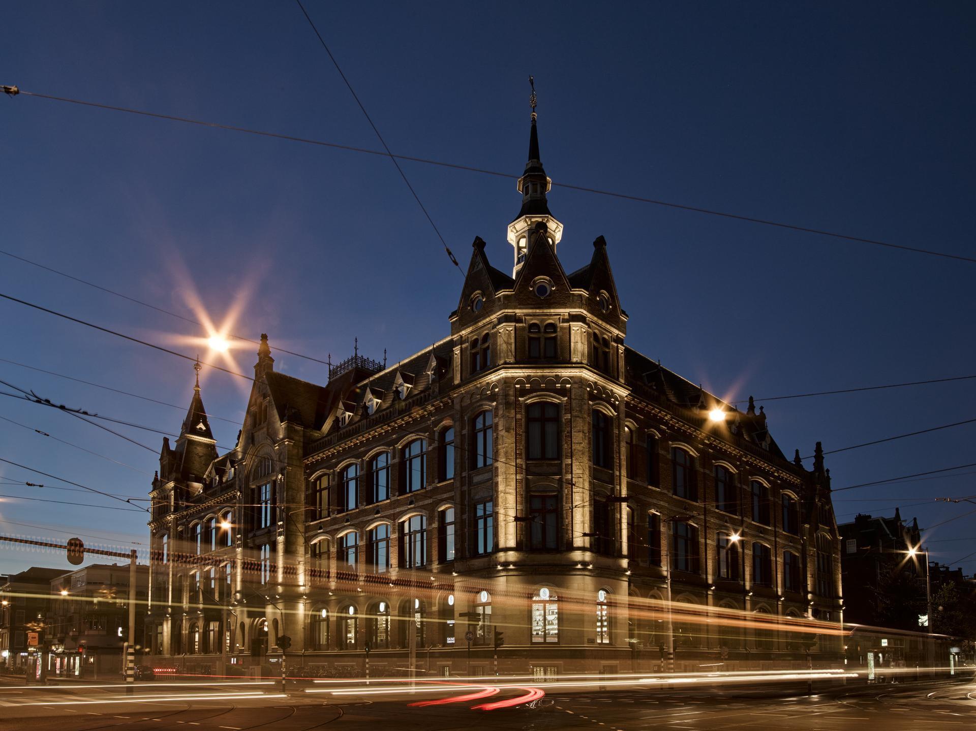 Mandarin Oriental Conservatorium, Amsterdam: the 19th-century landmark building exterior lit at dusk with its distinctive architecture and turrets