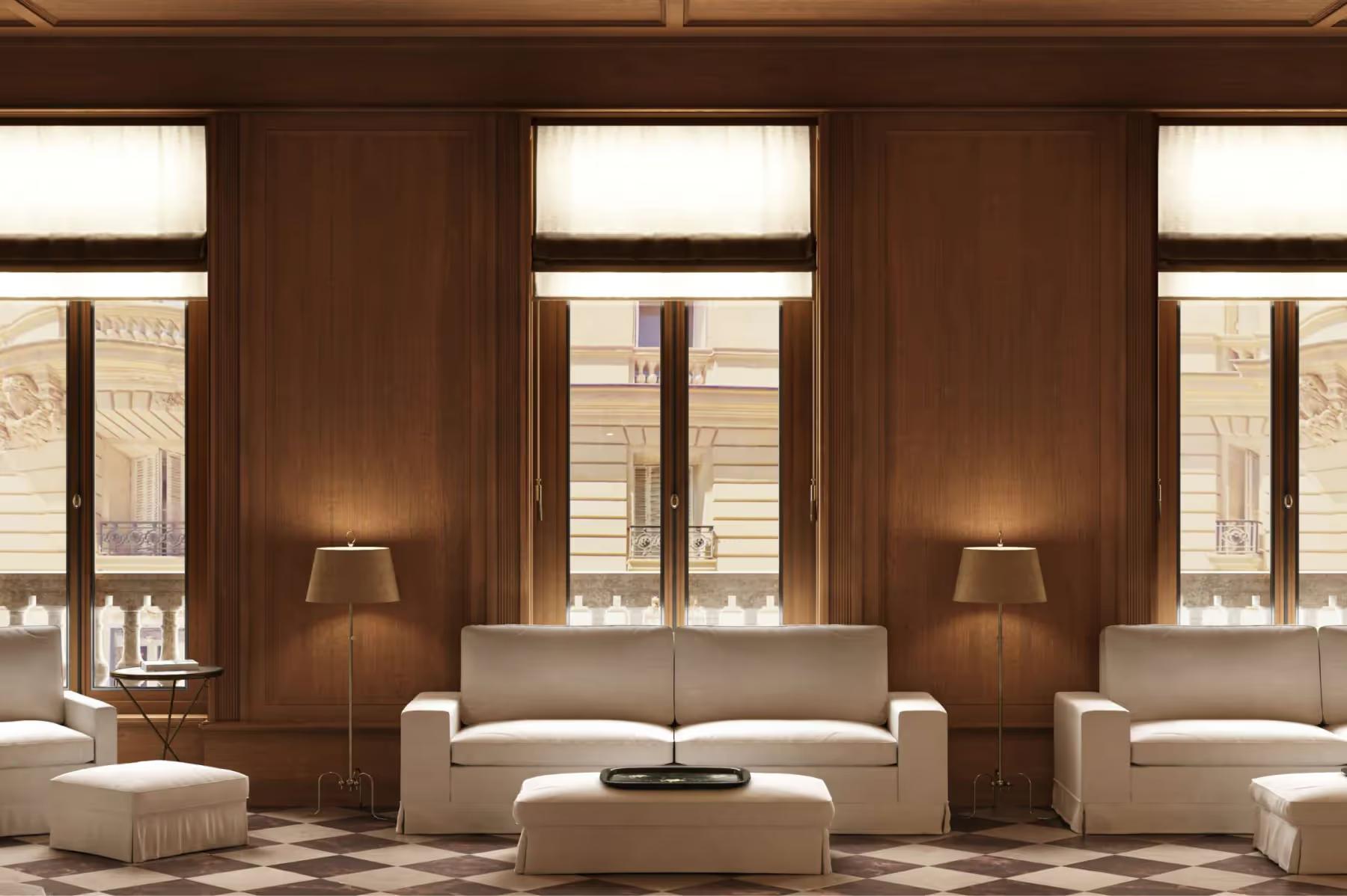 A wood-paneled salon with multiple windows, seating, and a fireplace