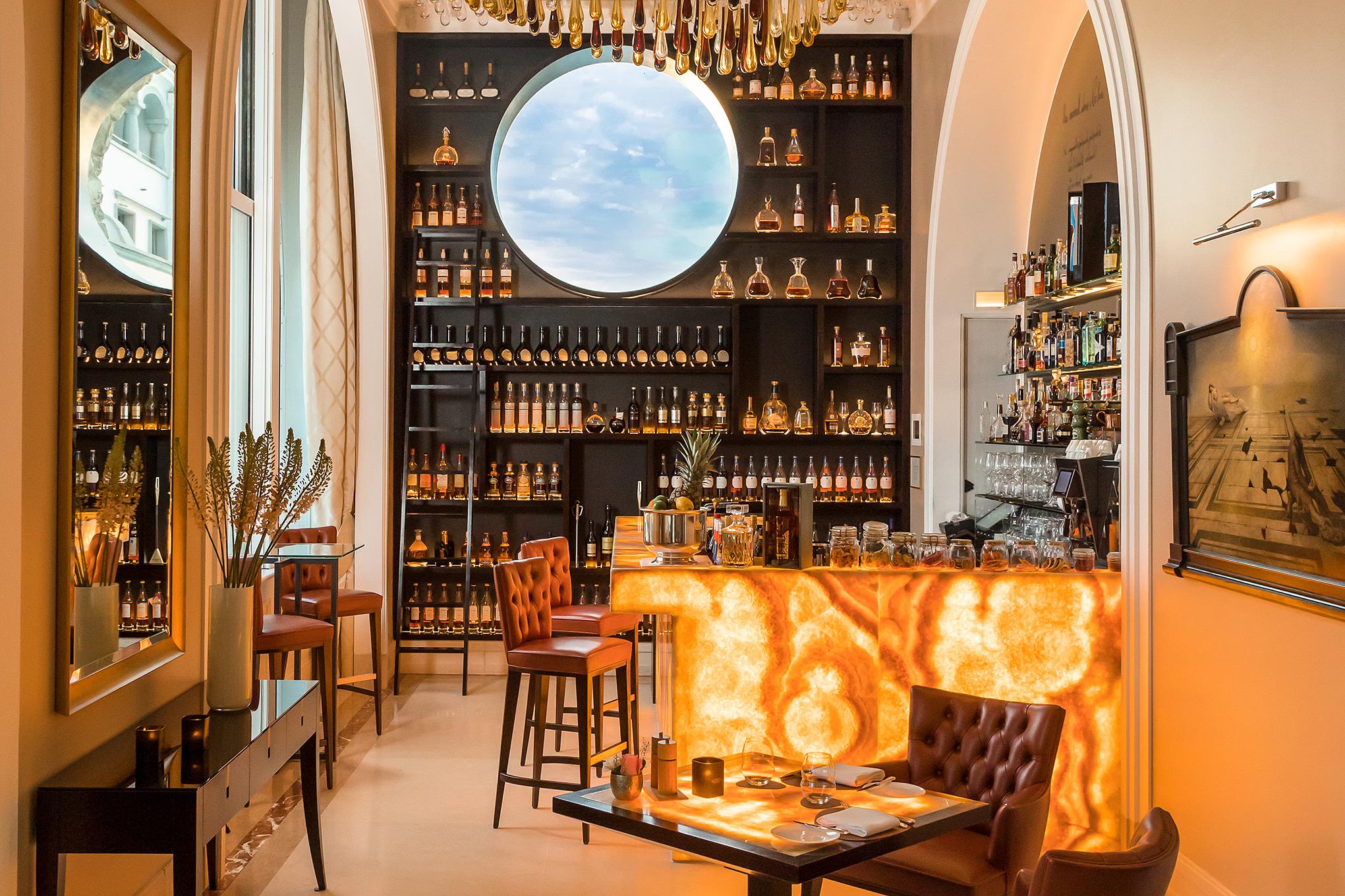 Park Hotel Vitznau: wine bar with illuminated shelving and circular window overlooking the lake