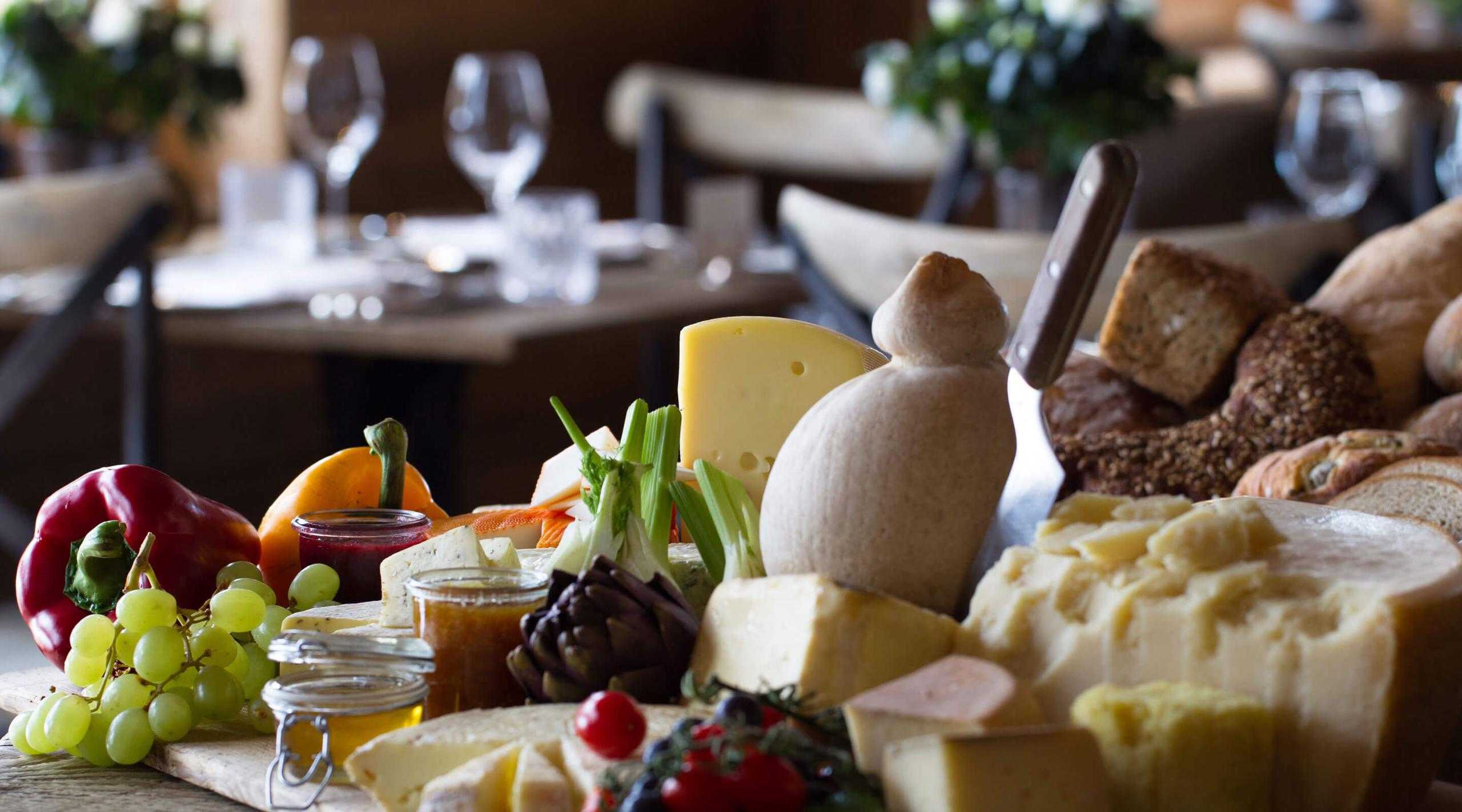 San Luis Retreat: plated cheese, fruit, and fresh produce with wine glasses in background