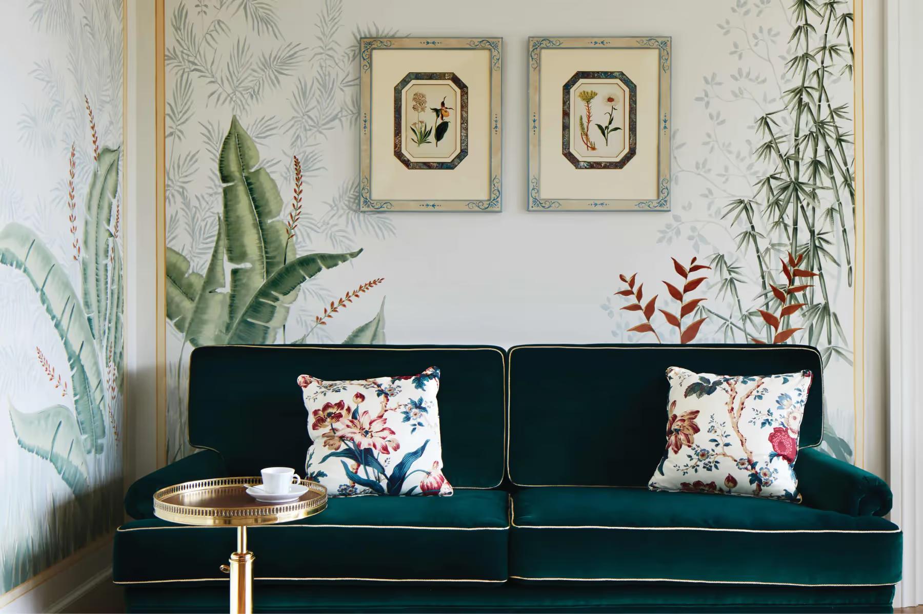 Splendido: a suite interior featuring botanical wallpaper, green sofa, and sea-view glass doors