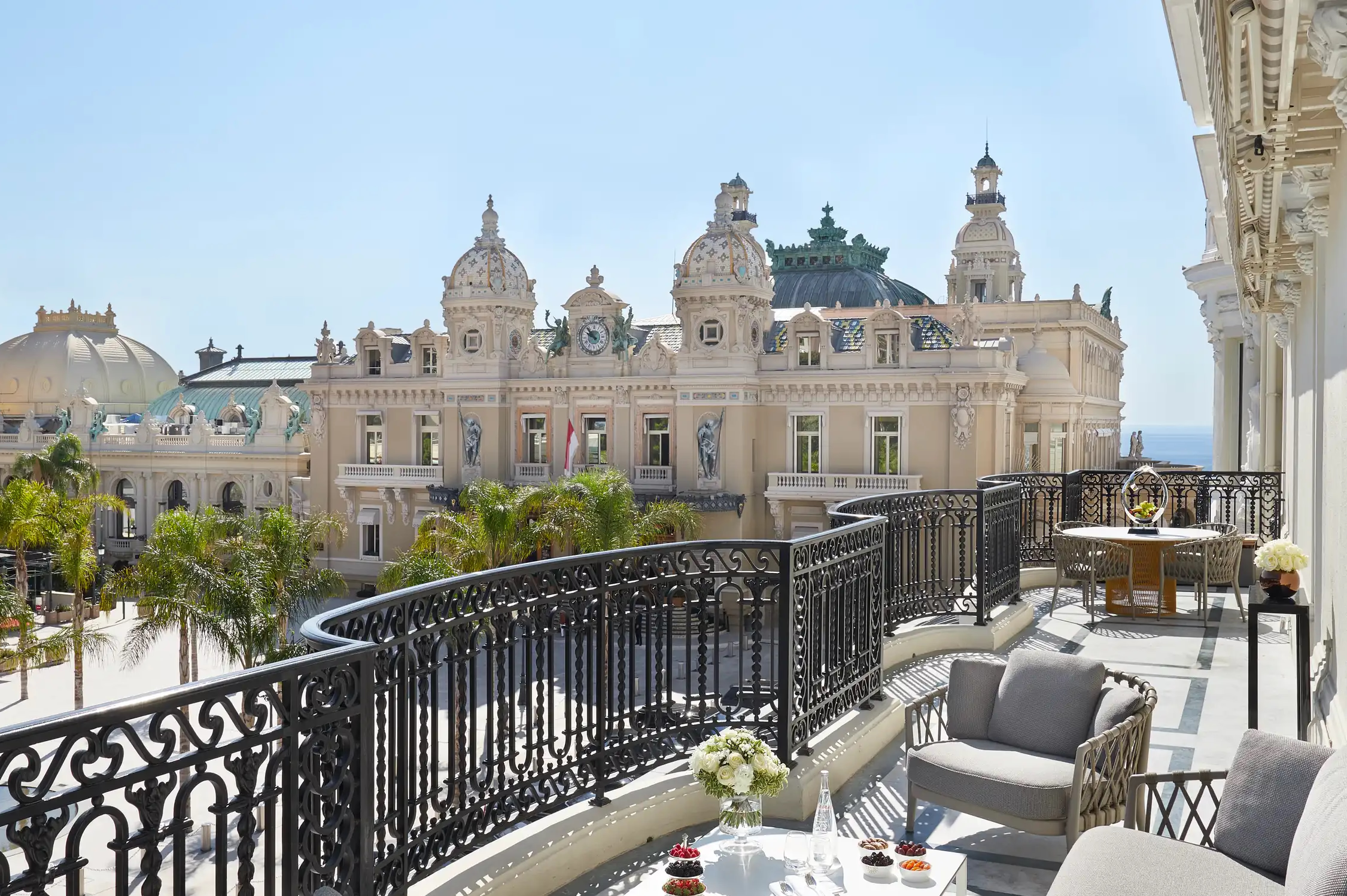 Balcony view of palazzo domes and Mediterranean beyond iron railing