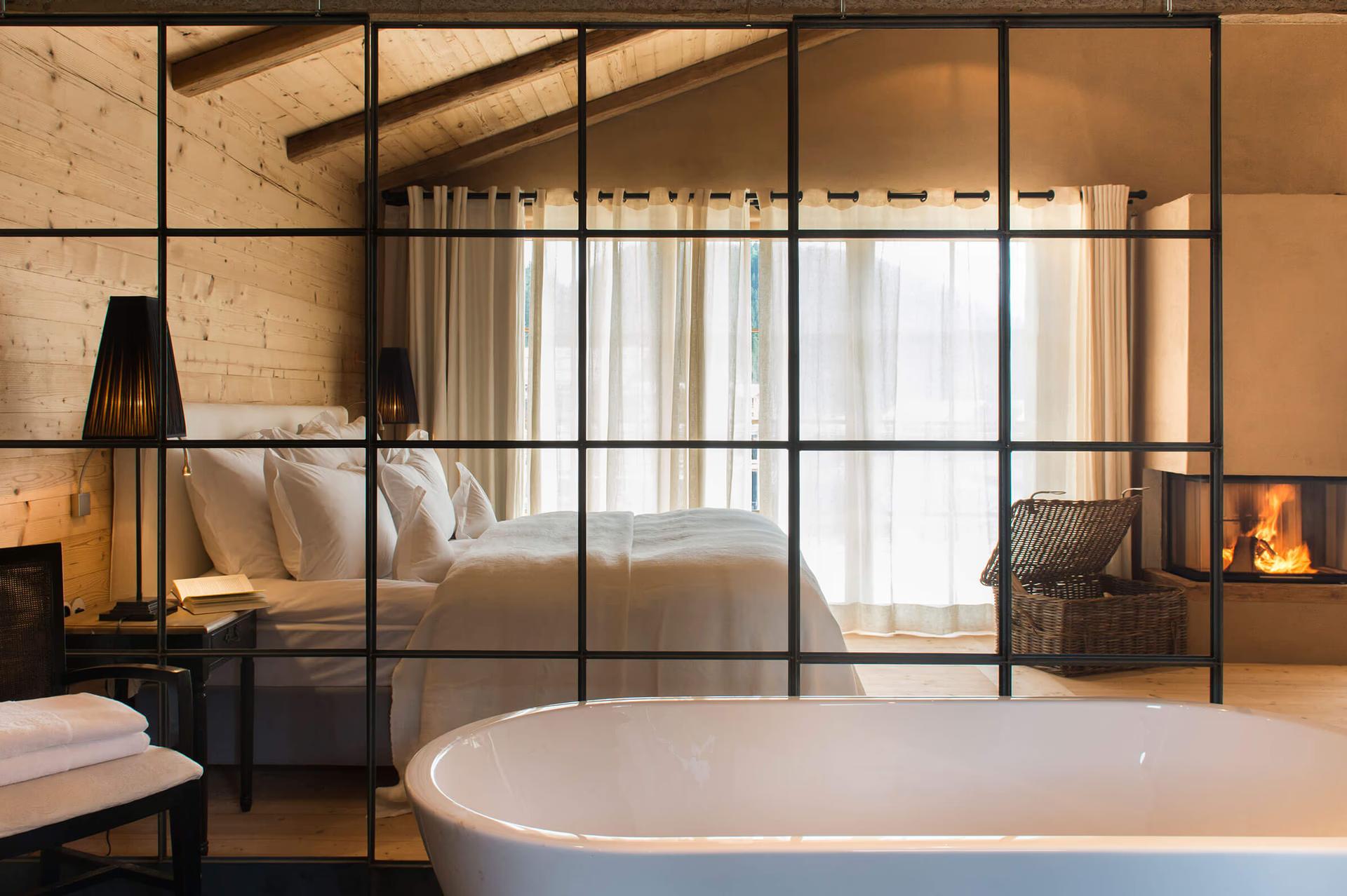 San Luis Retreat: modern freestanding white soaking tub with a frame partition and mountain view
