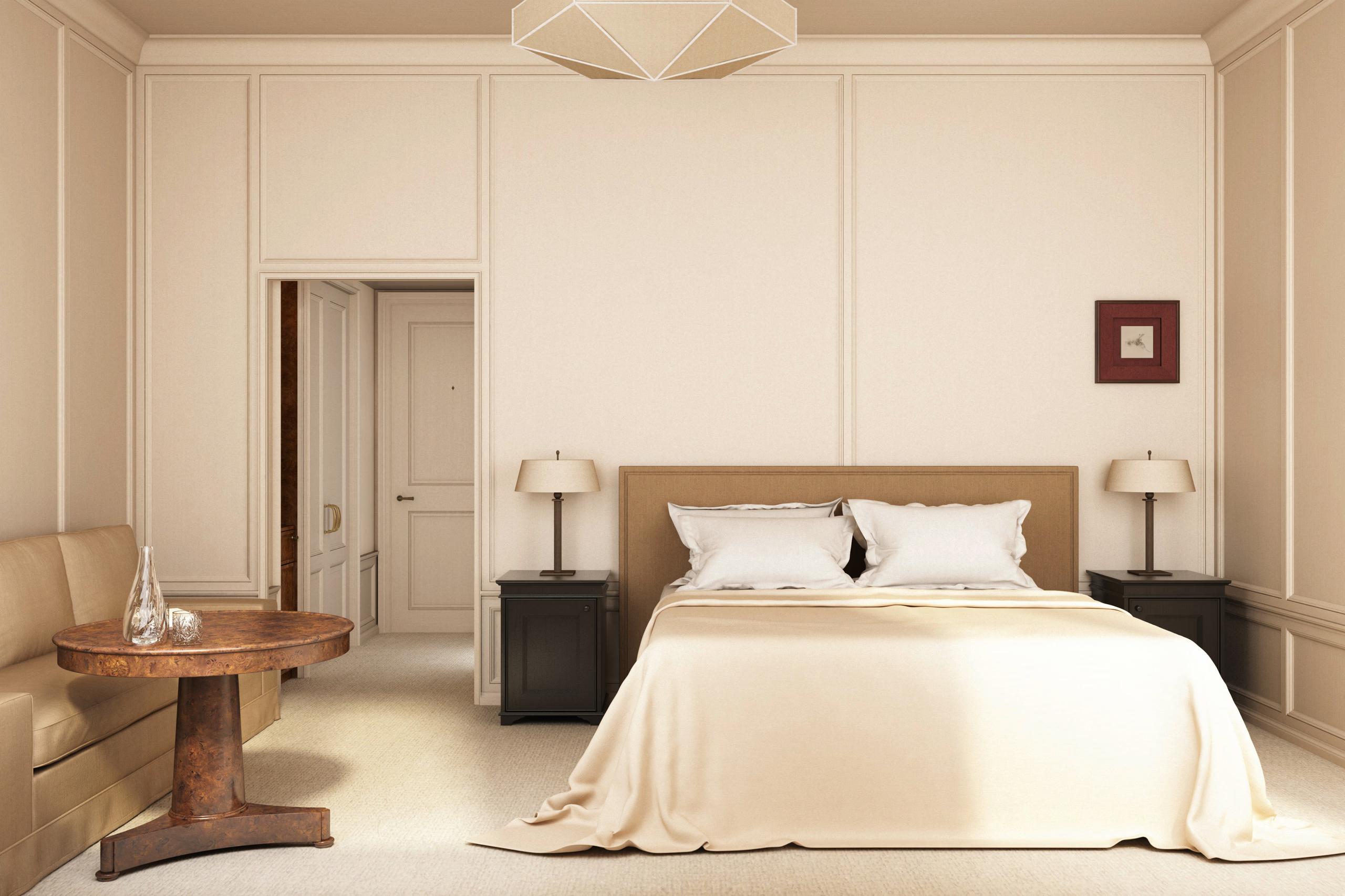 Hôtel Balzac: a spacious bedroom with cream walls, a wood bed frame, and high ceiling