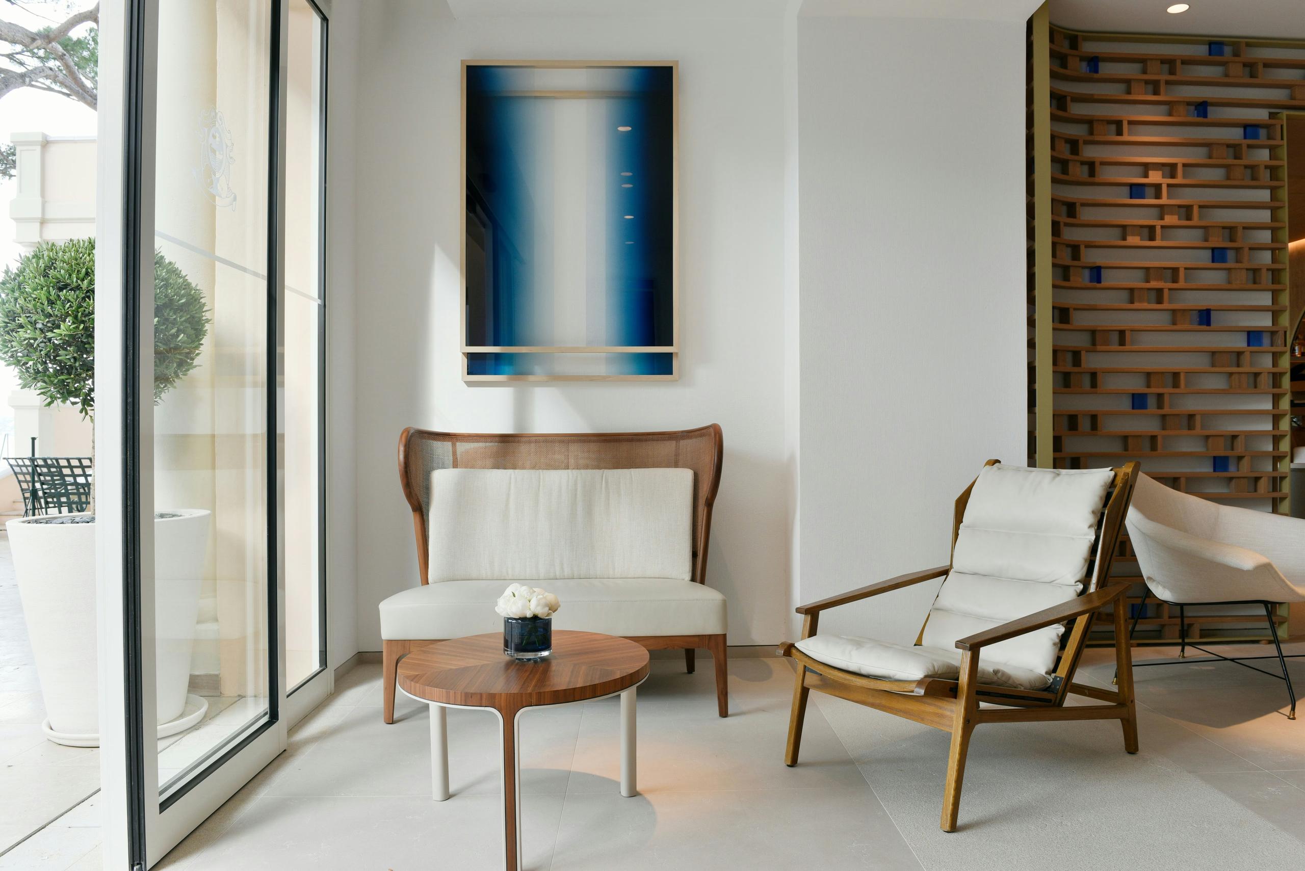 Cheval Blanc St-Tropez: living space with blue abstract artwork and wooden furniture