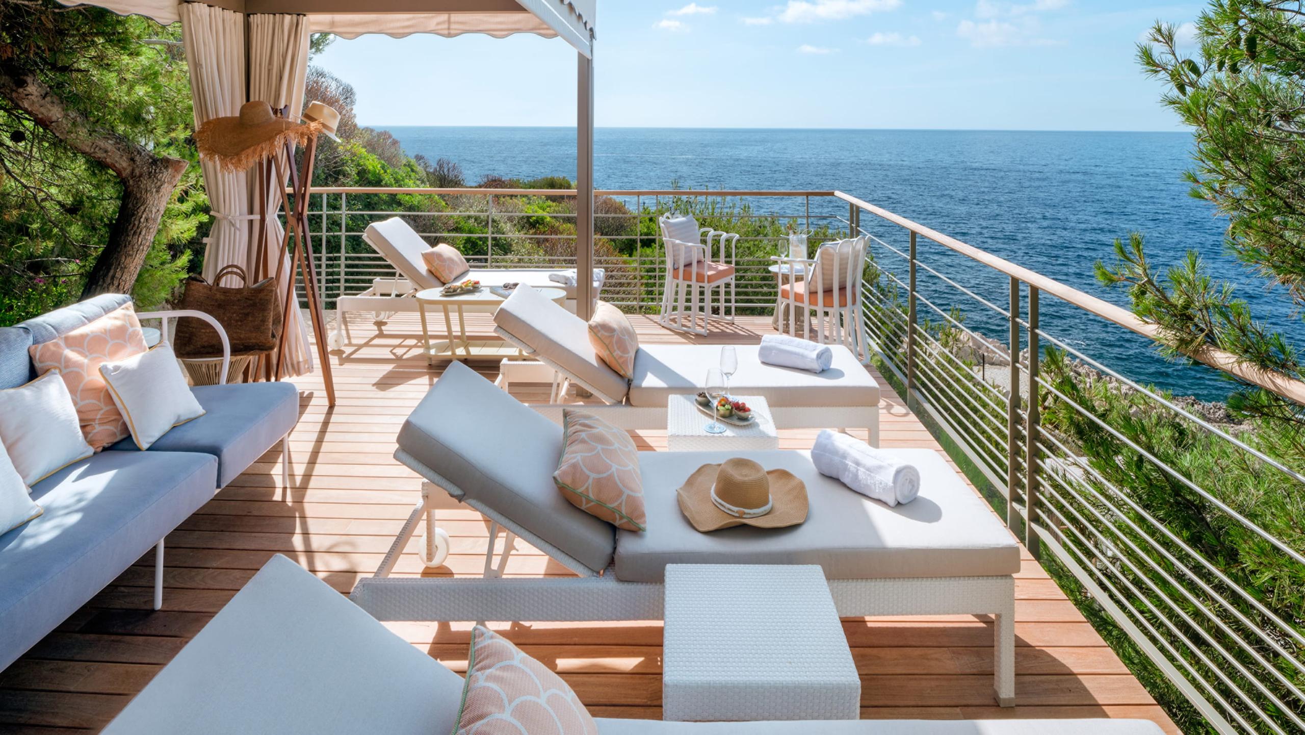 Grand-Hôtel du Cap-Ferrat: oceanfront suite terrace with lounge beds and sea-view railing