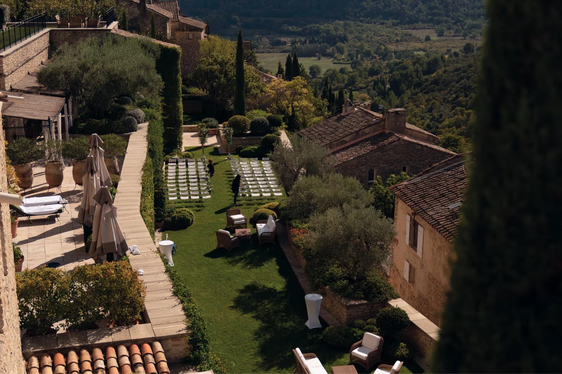 Airelles Gordes, La Bastide: aerial view of stone terraces, gardens, and distant valley from the hilltop property