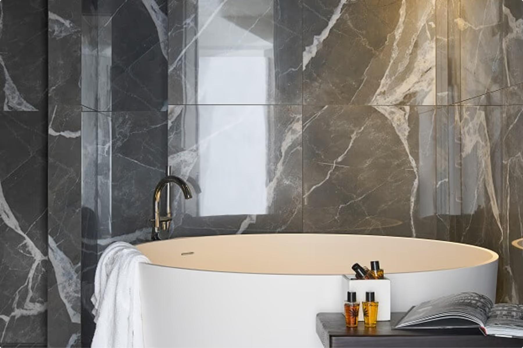 Spa-style bathroom with white freestanding tub and decorative vessel mirror