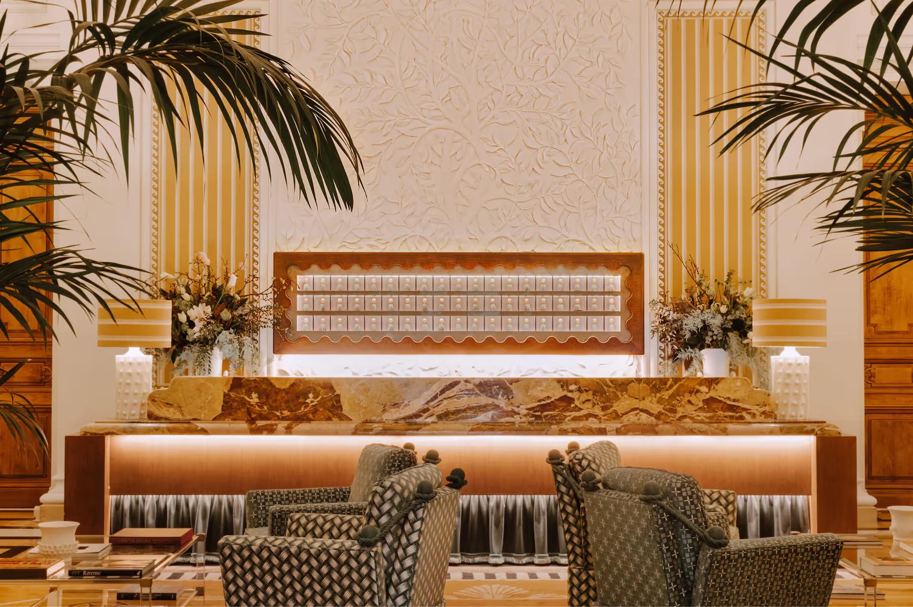 Saint James: reception seating with modern upholstered furniture and tropical plant arrangement