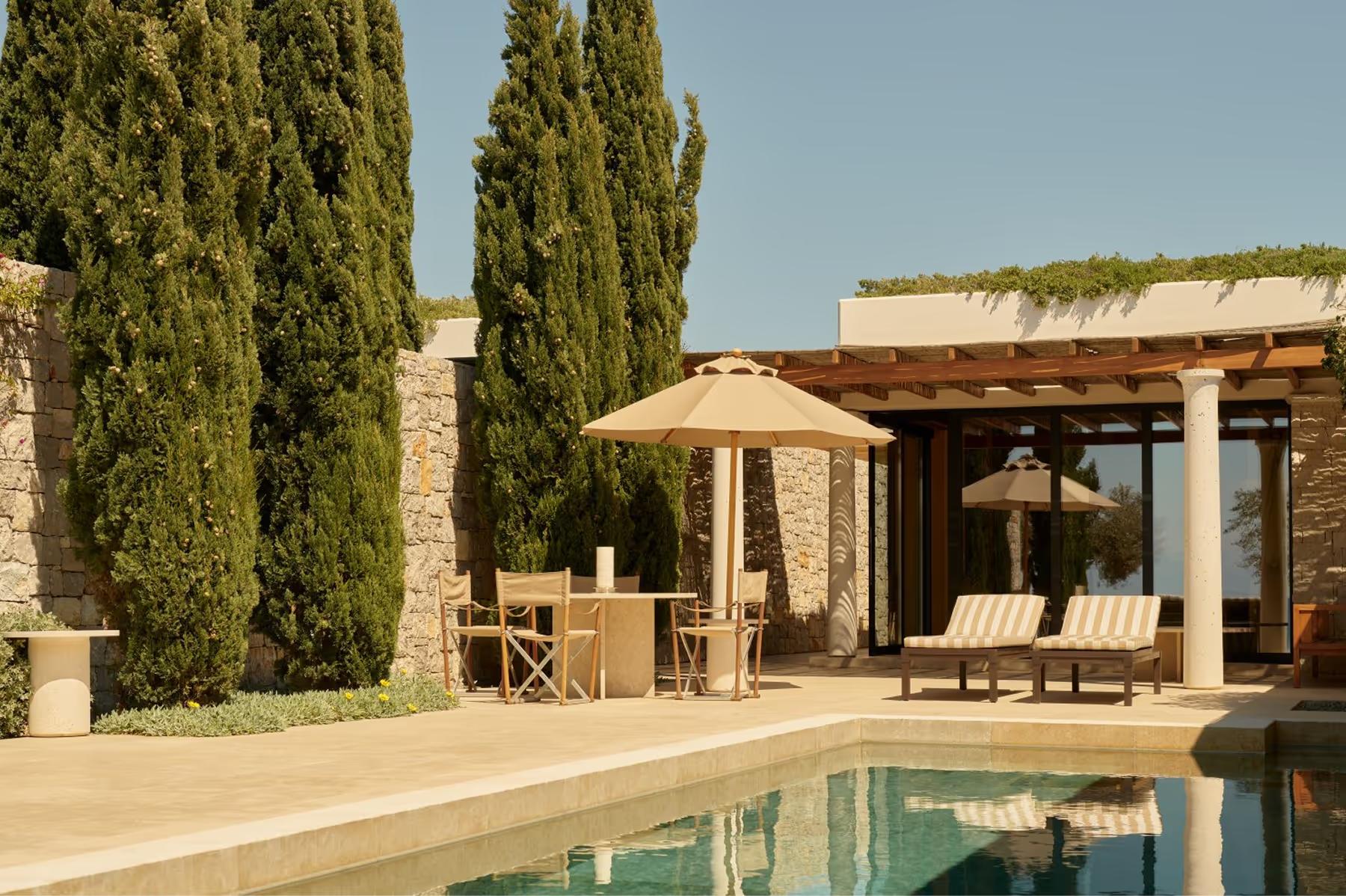 Amanzoe: pool-adjacent loungers overlooking the Peloponnesian coast at dusk