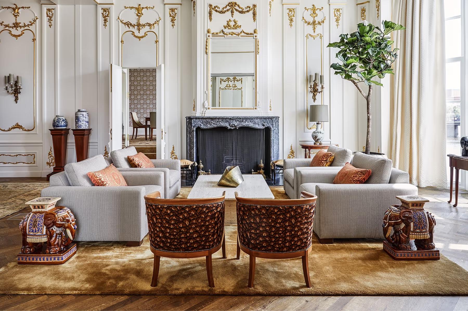 De L’Europe Amsterdam: living room with cream seating, fireplace, arched windows, and classical proportions