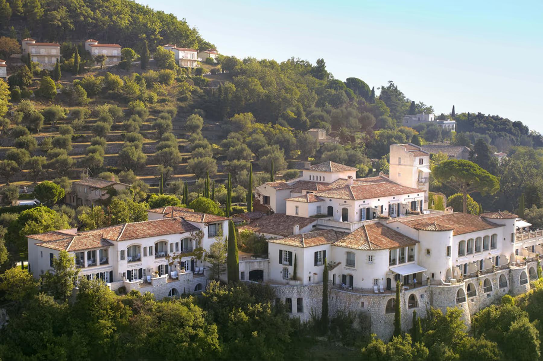 Château Saint Martin & Spa: château buildings on a steep forested hillside with Mediterranean views