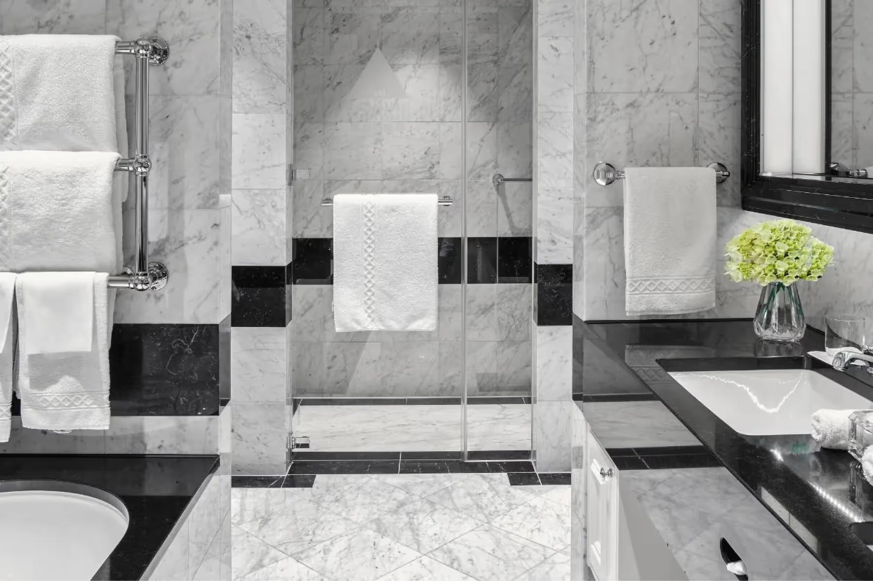 Marble bathroom with black and white geometric tile pattern