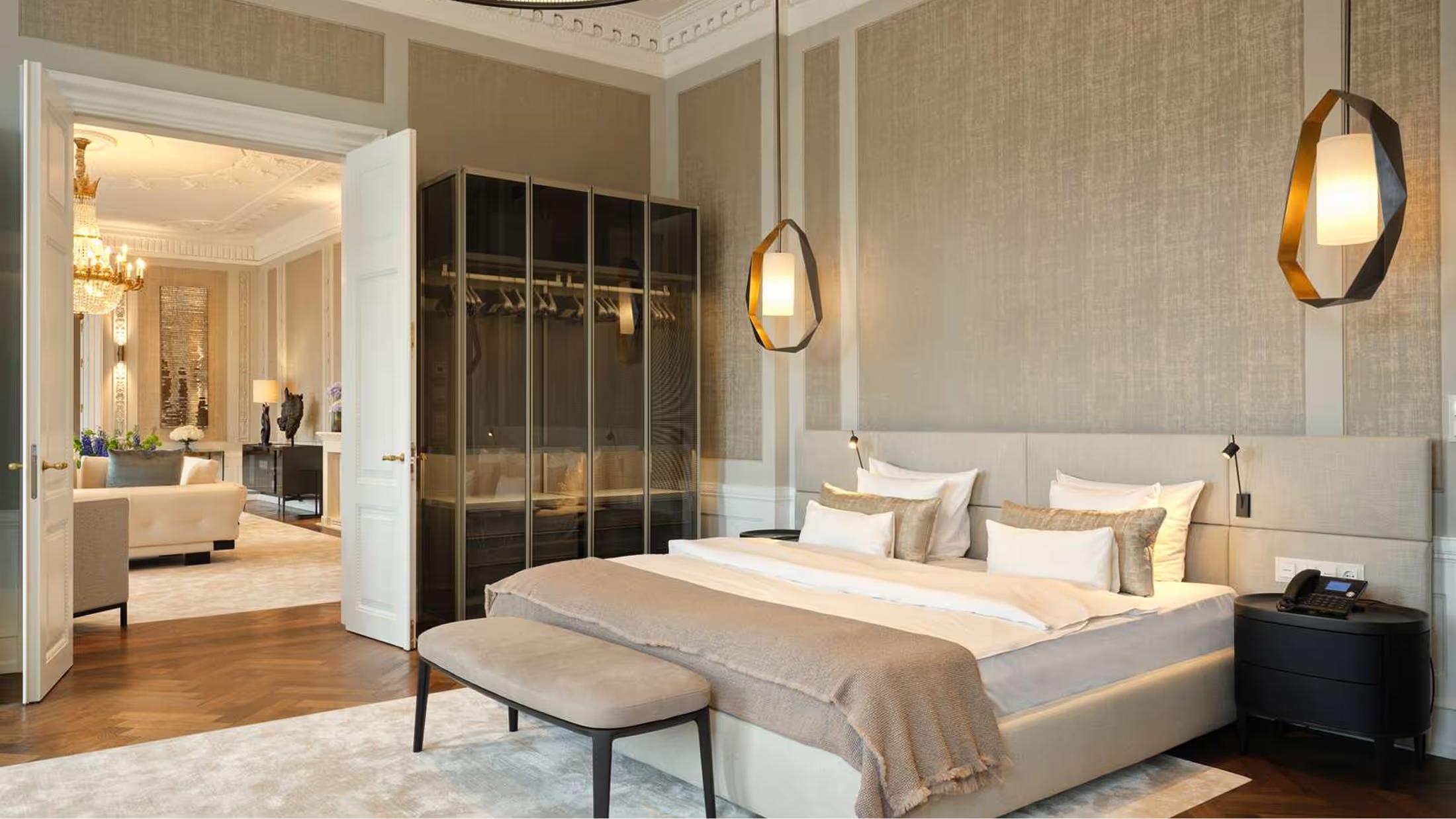 A suite bedroom with smoked oak furnishings and brass pendant lights