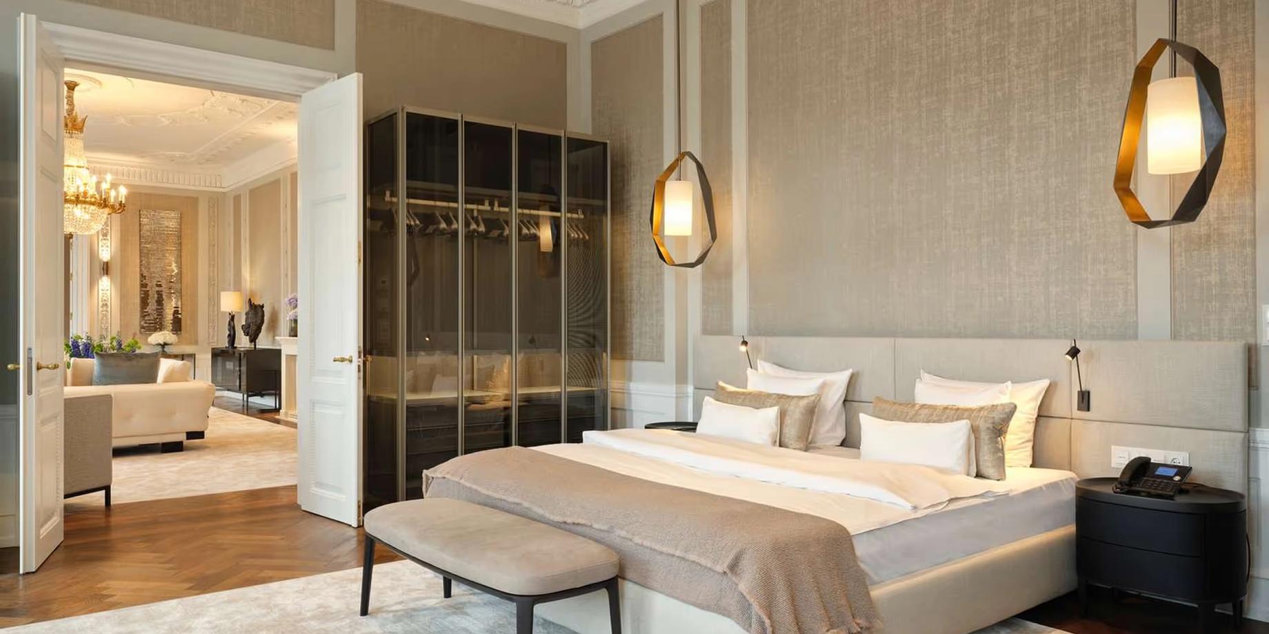 A suite bedroom with smoked oak furnishings and brass pendant lights