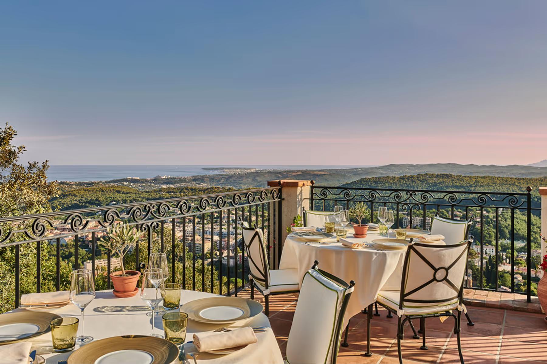Terrace dining table at dusk with Mediterranean and village views