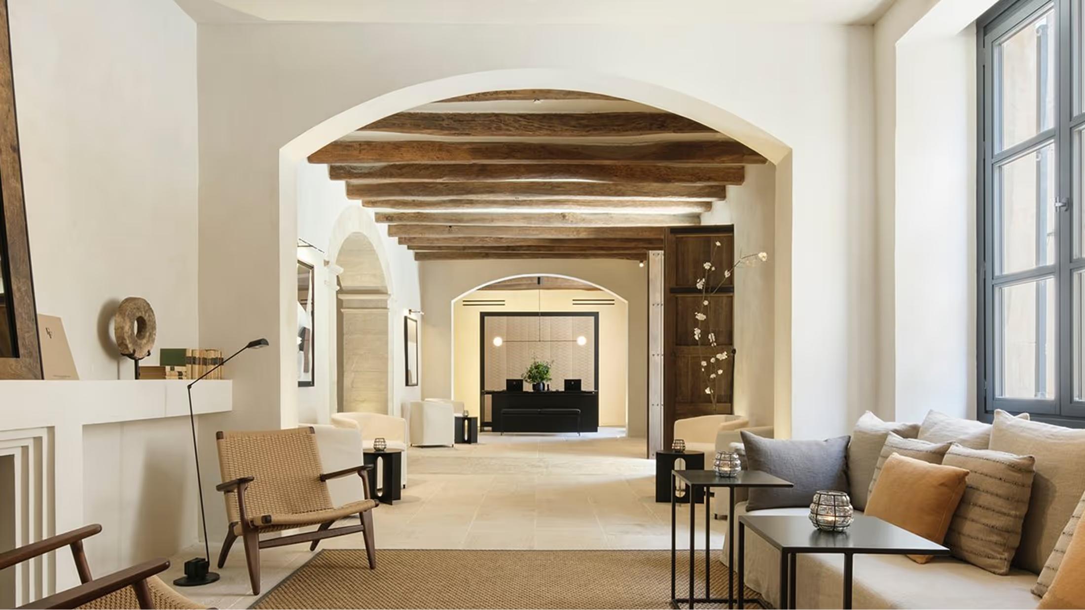 Warm interior hallway with exposed wooden beams and arched entryways