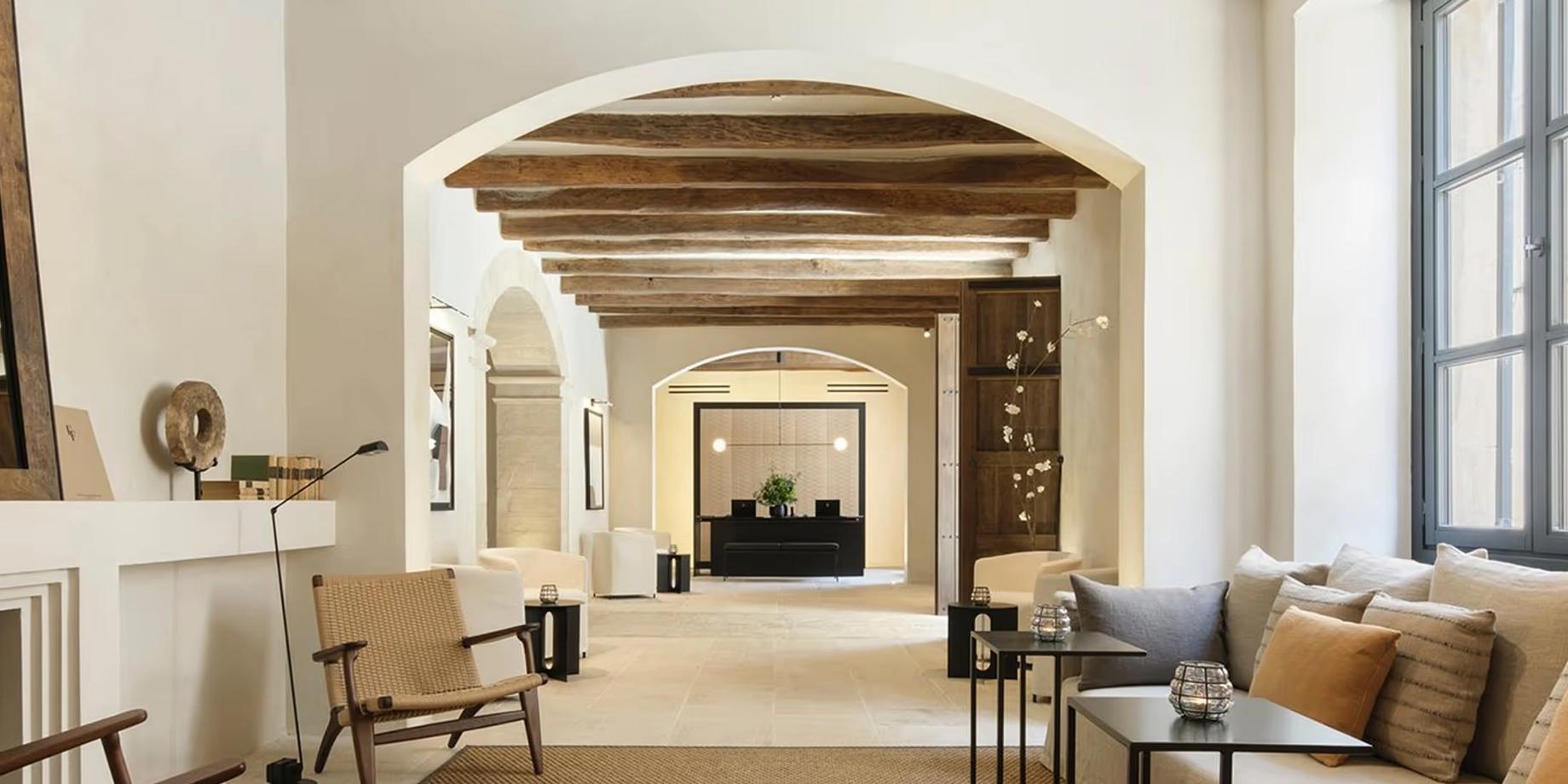 Warm interior hallway with exposed wooden beams and arched entryways
