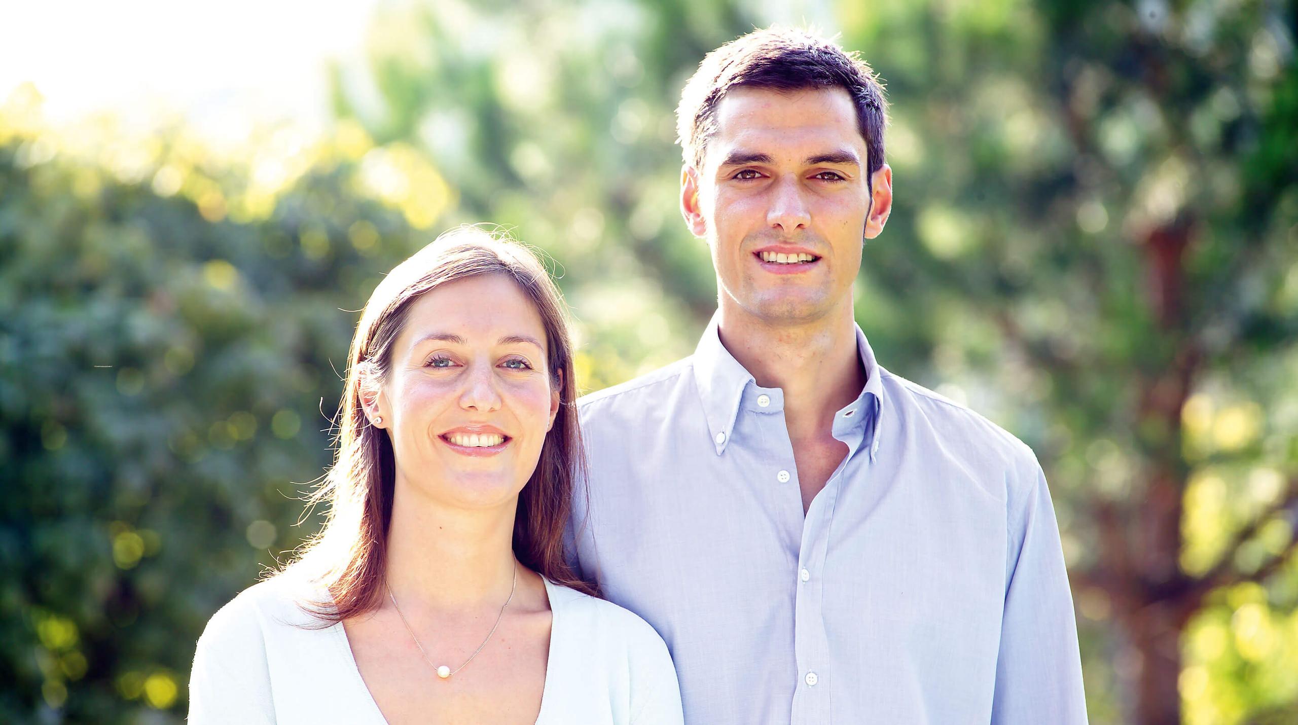 San Luis Retreat: two people smiling outdoors with green foliage in background