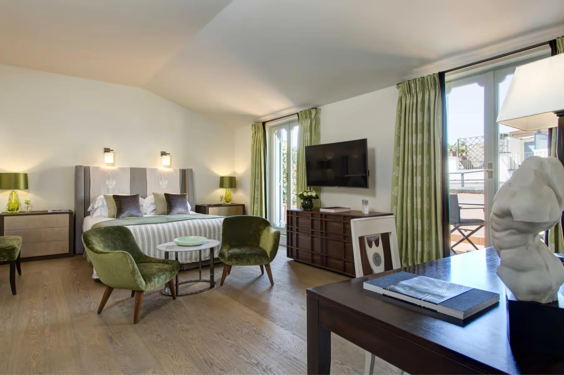 Hotel de Russie: bedroom suite with green velvet seating, striped bedding, and glass doors to a terrace