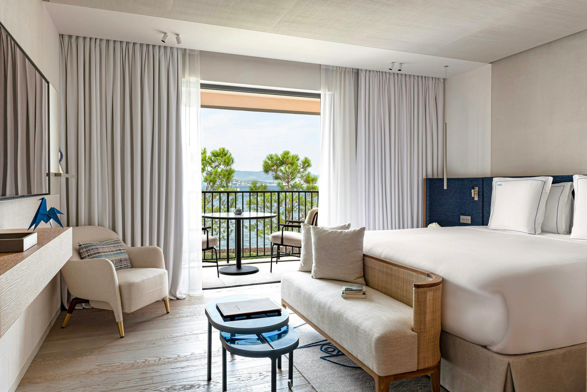 Cheval Blanc St-Tropez: suite with neutral palette, two beds, and terrace with tree views