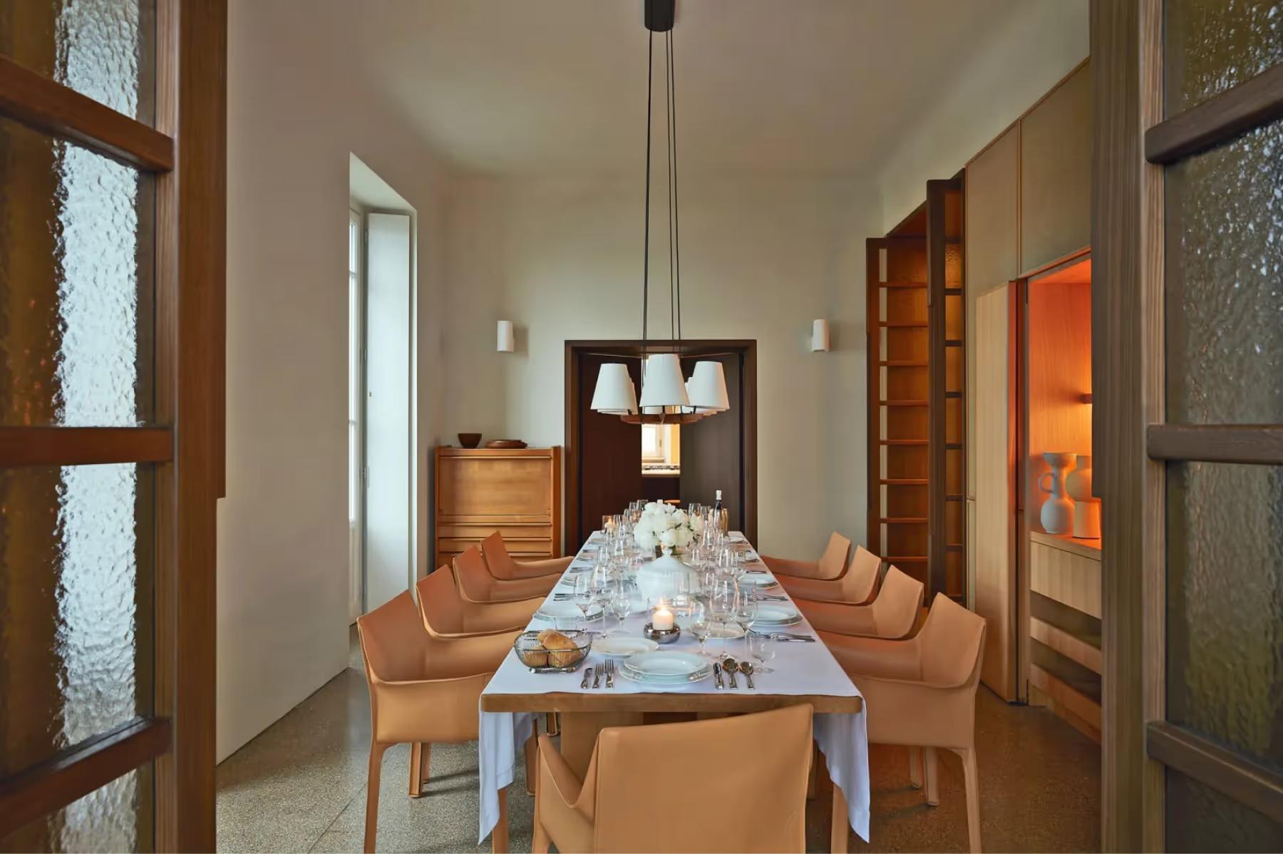 Villa Patrizia: an elegant dining hall with wooden table, high ceilings, and natural light