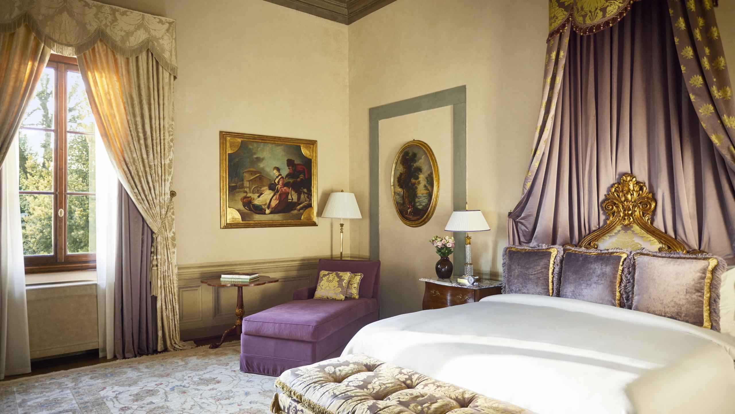Four Seasons Hotel Firenze: bedroom with sage walls, pale wood ceiling, classical oil paintings, and purple velvet accent chair