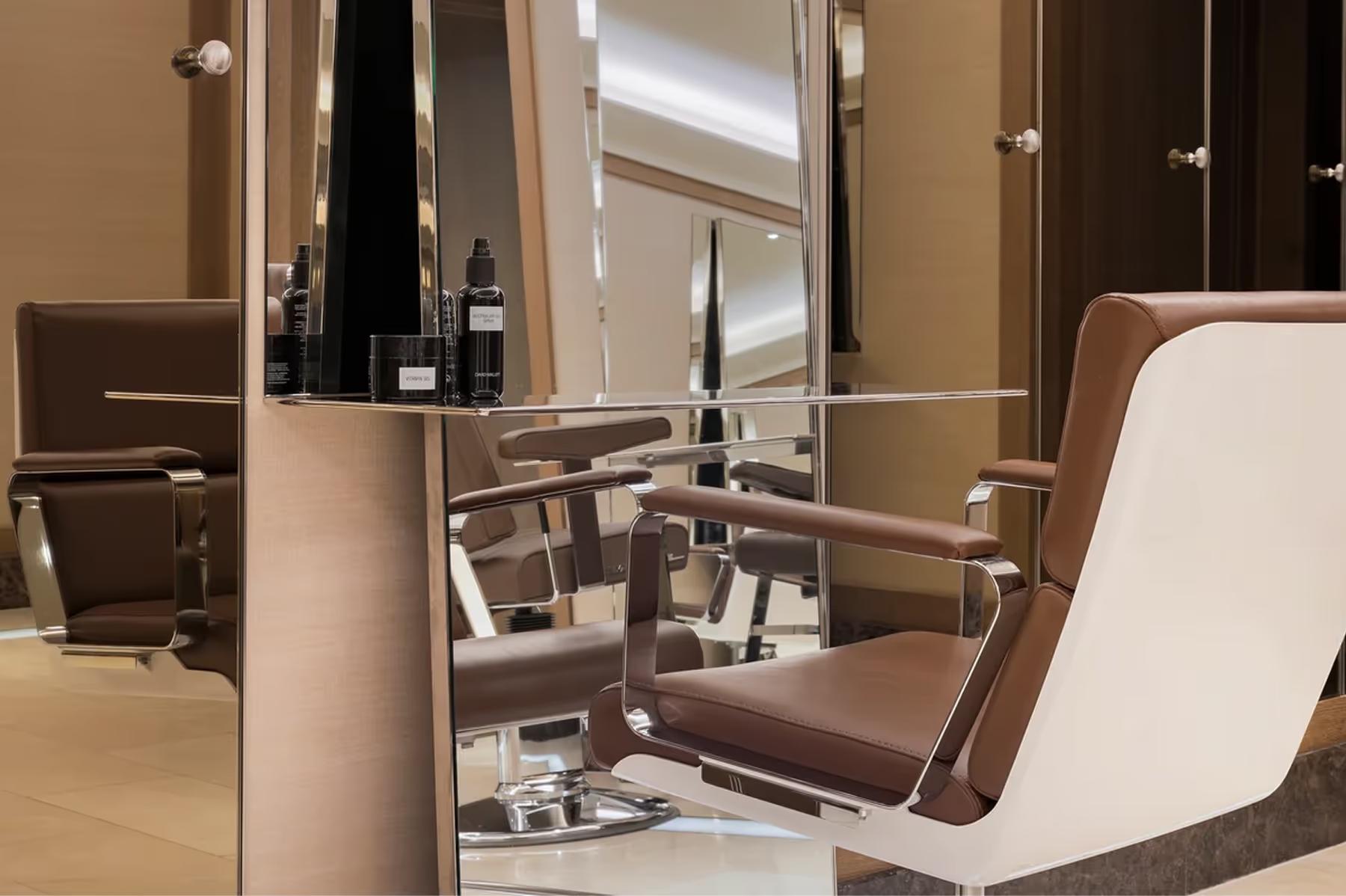 A salon styling station with mirrors and professional treatment chair