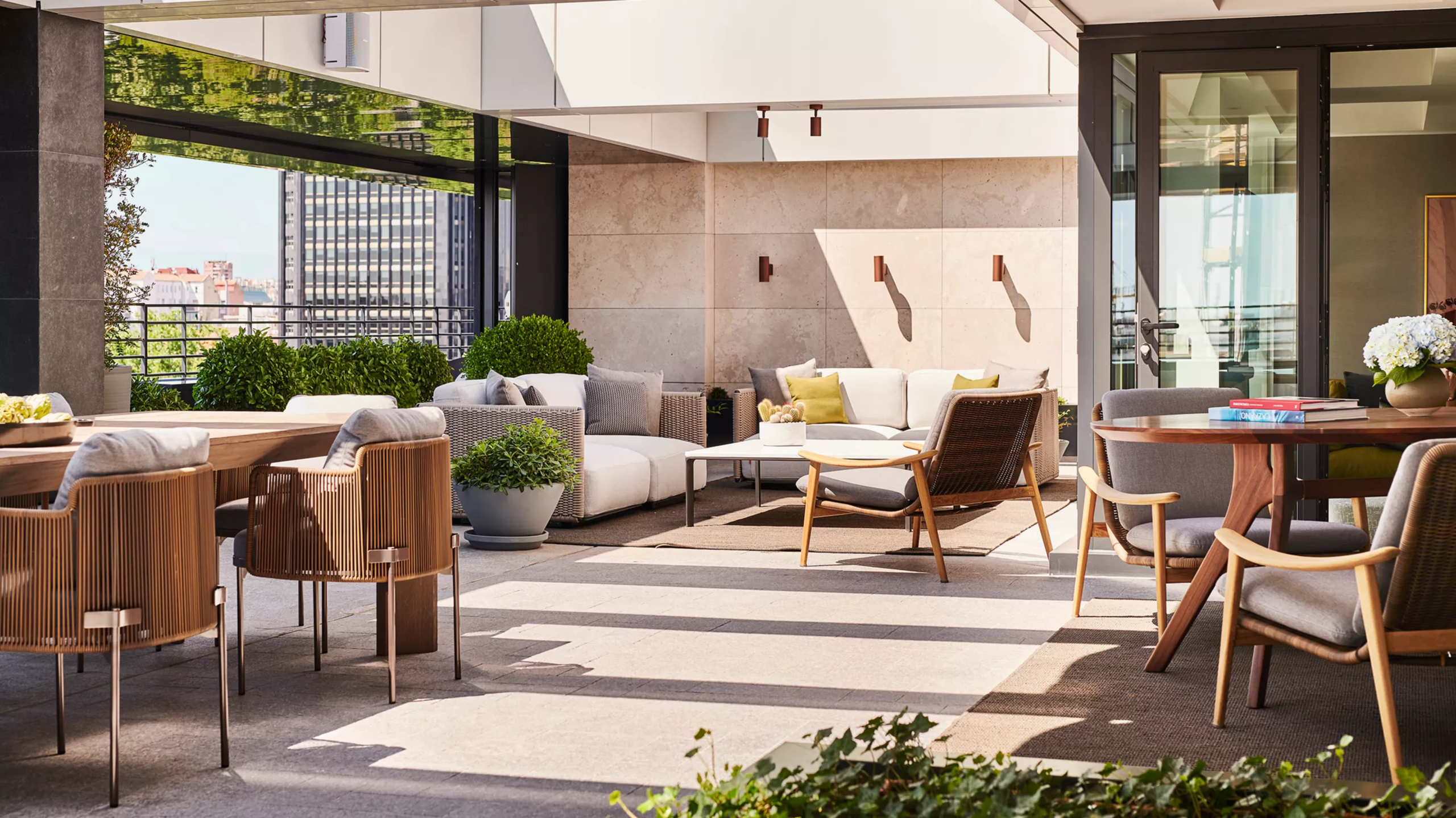 Rosewood Villa Magna: a covered courtyard with lounge seating, neutral upholstery, and skylight above